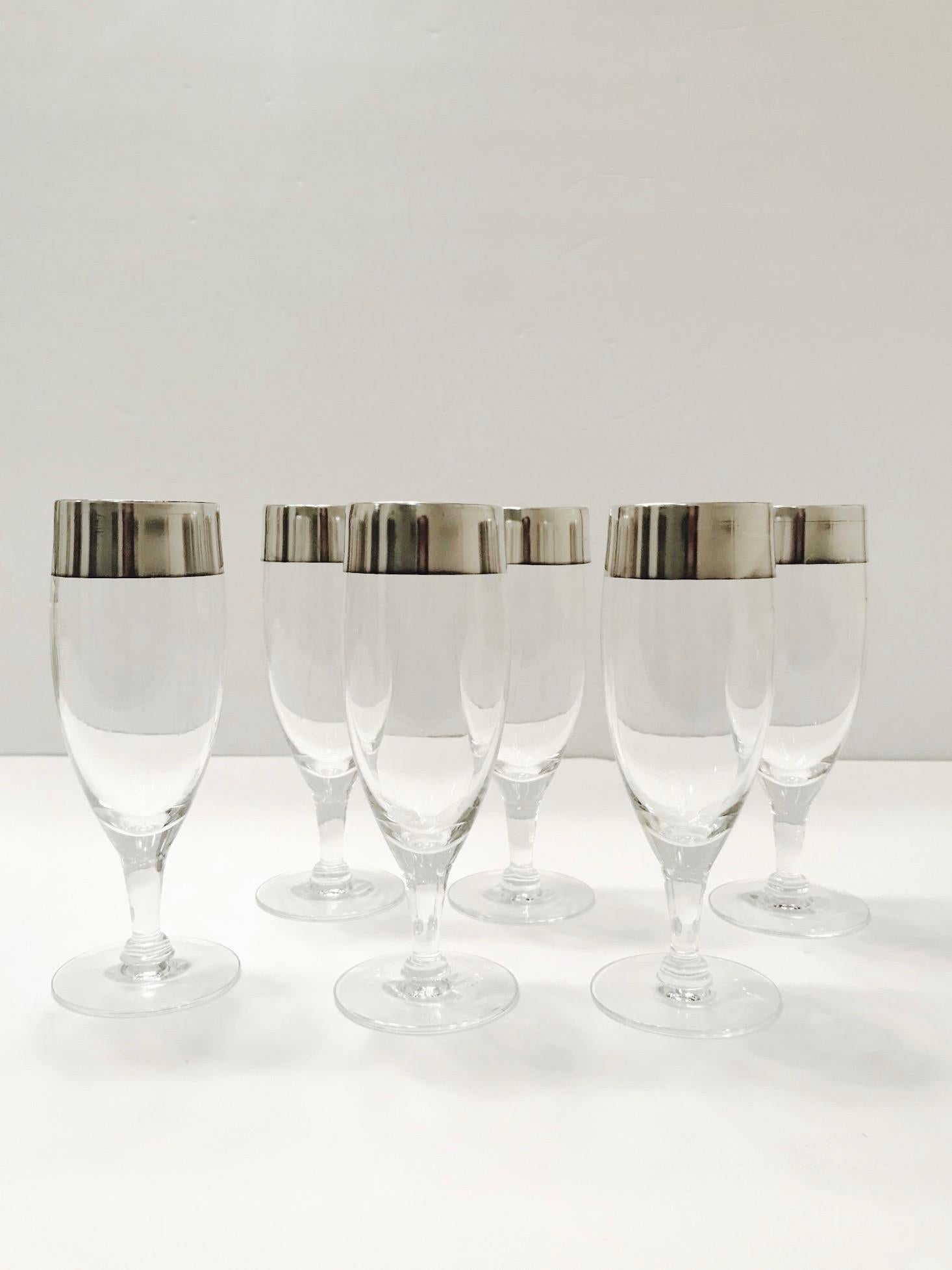 Set of six elegant Mid-Century Modern stemware glasses designed by Dorothy Thorpe. The rare champagne glasses feature short stems with the iconic sterling silver rims for which Thorpe is recognized and highly sought after. These make an excellent