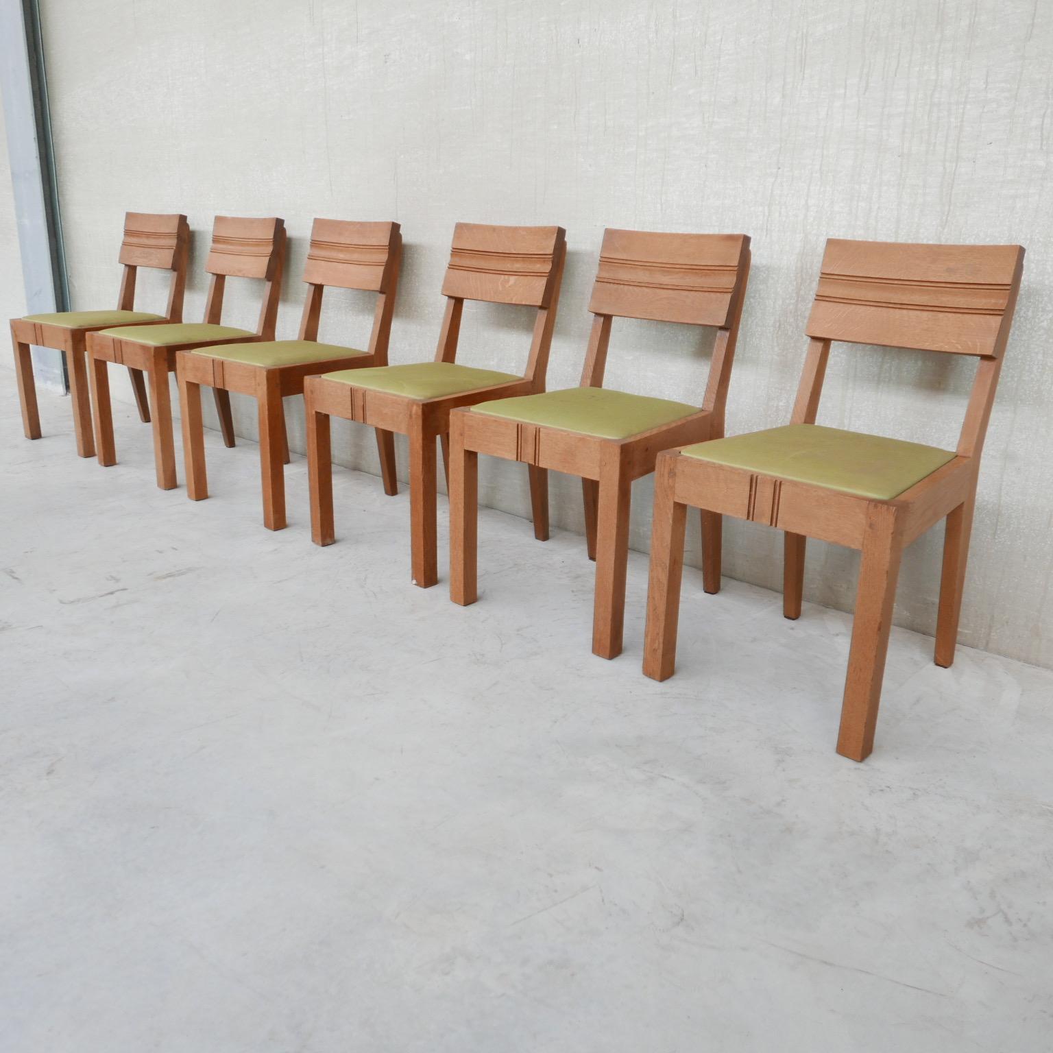 A set of six oak dining chairs attributed to Charles Dudouyt. 

France, c1940s. 

Oak construction with upholstered seats, the upholstery needs updating as it has some stains, which we can arrange in house upon request. 

The set remains in