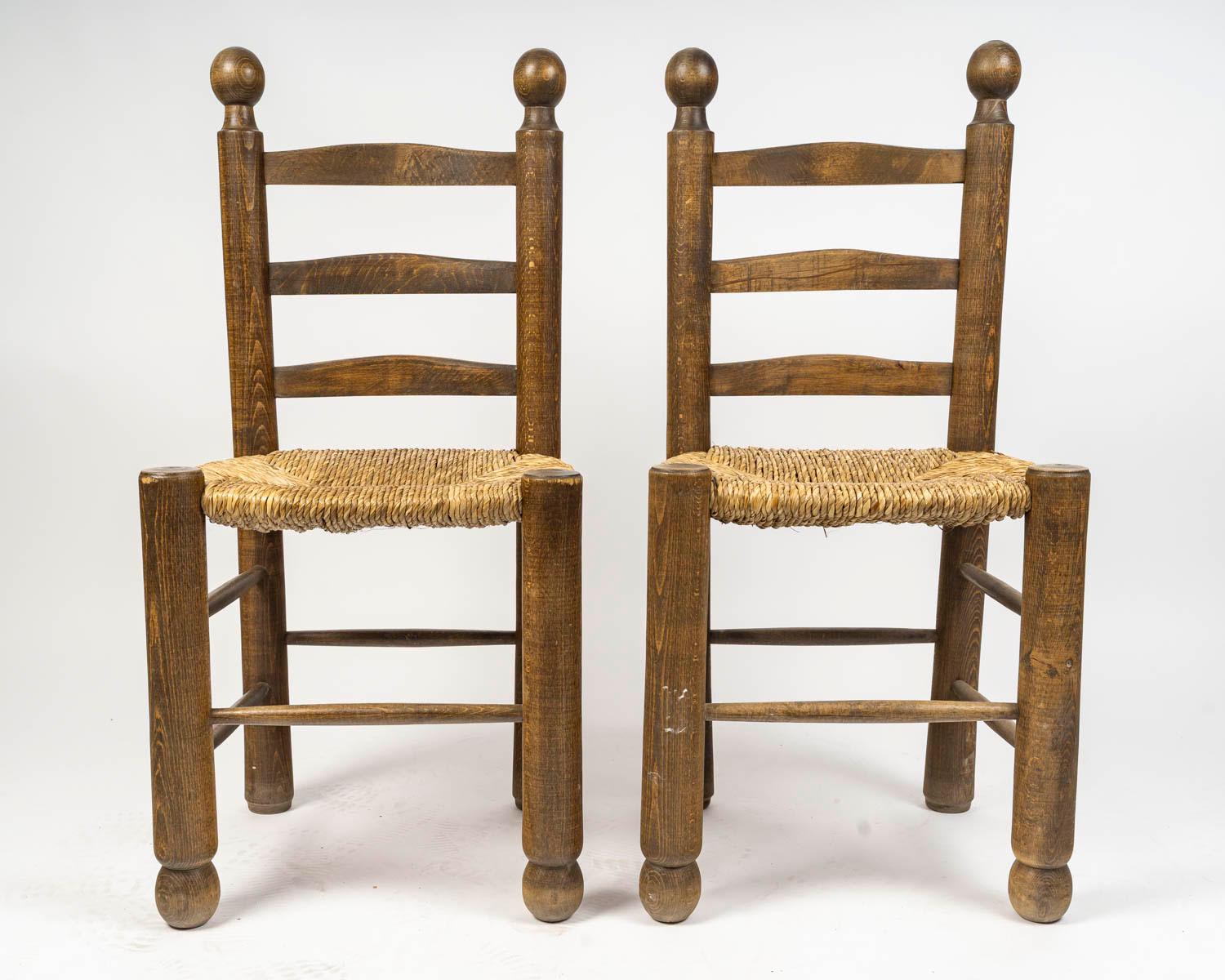 Set of six Charles Dudouyt dining chairs in wood and cane, 20th century.

Set of six Charles Dudouyt dining chairs, four identical chairs for the sides of the table and two identical but slimmer chairs for each end of the table. Oak and cane, circa
