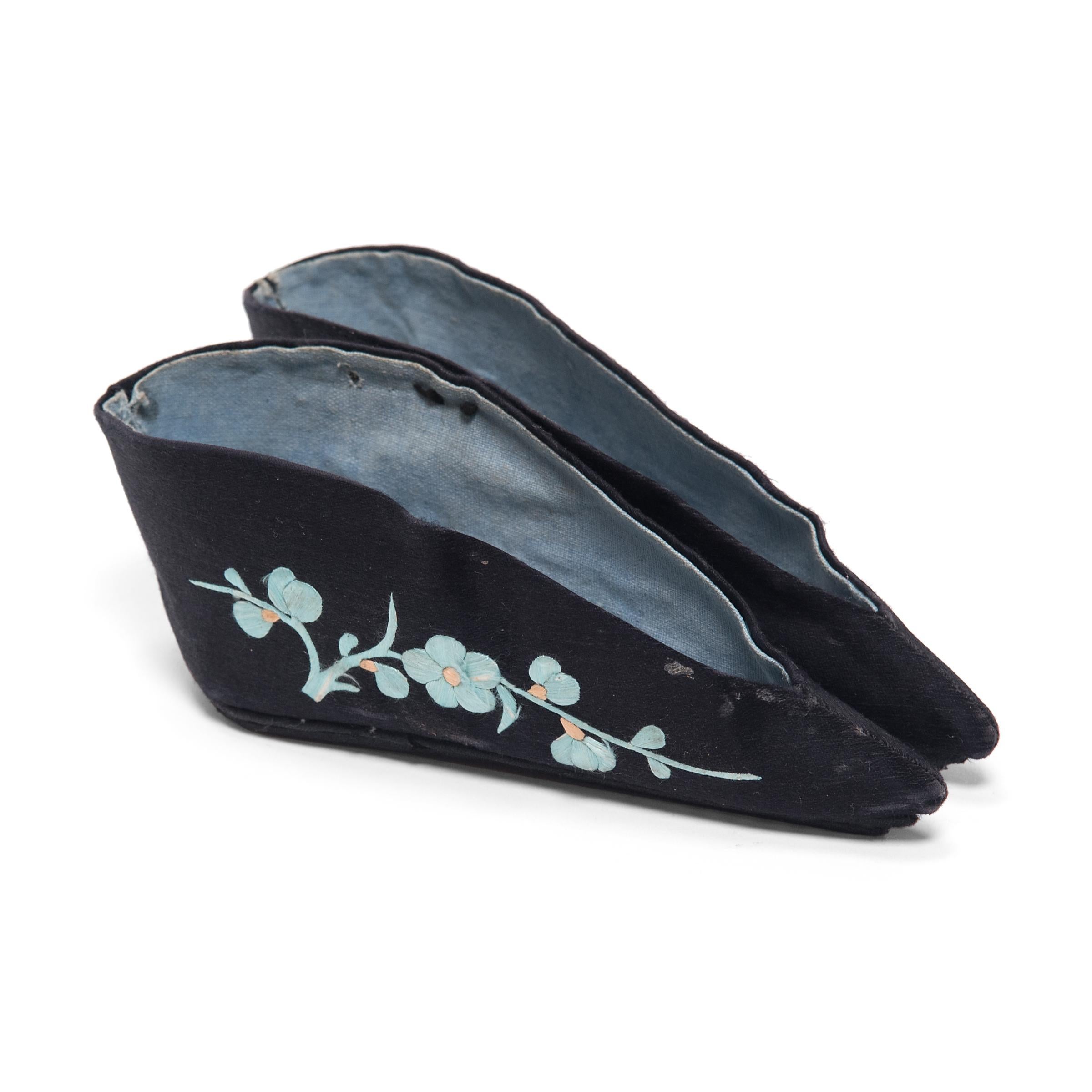 Each of these pointed slippers, crafted of beautifully embroidered silk, were shaped to resemble a lotus bud and enhanced the diminutive shape of bound feet. A practice that began in the Tang dynasty and reached the height of its popularity during