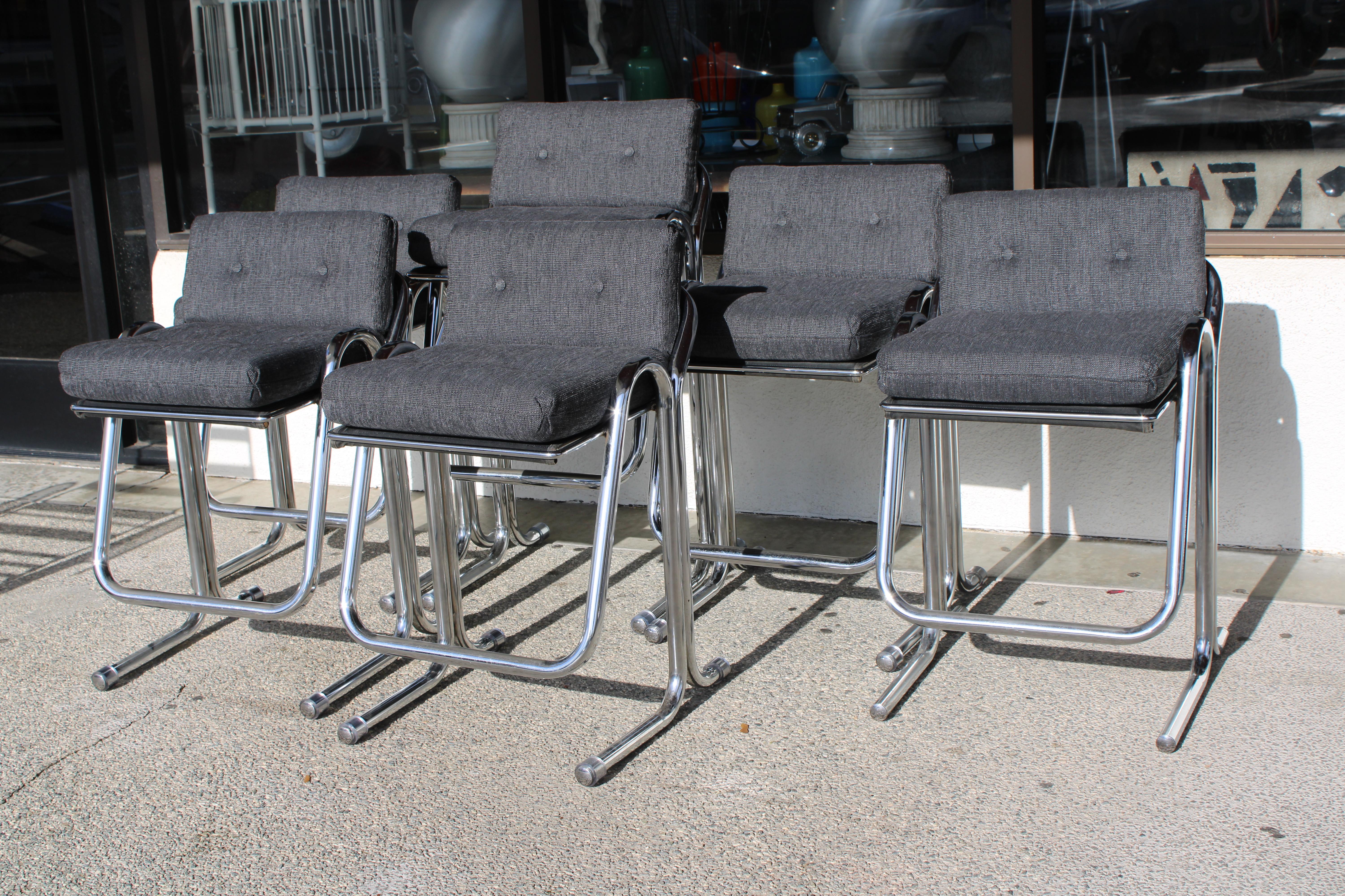 Set of six polished chrome bar stools by Jerry Johnson.  Newly recovered in a knoll fabric. The tall barstool measures 20.5” wide, 20” deep, 39.5” high with a seat height of 32”. The five smaller barstools measures 20.5