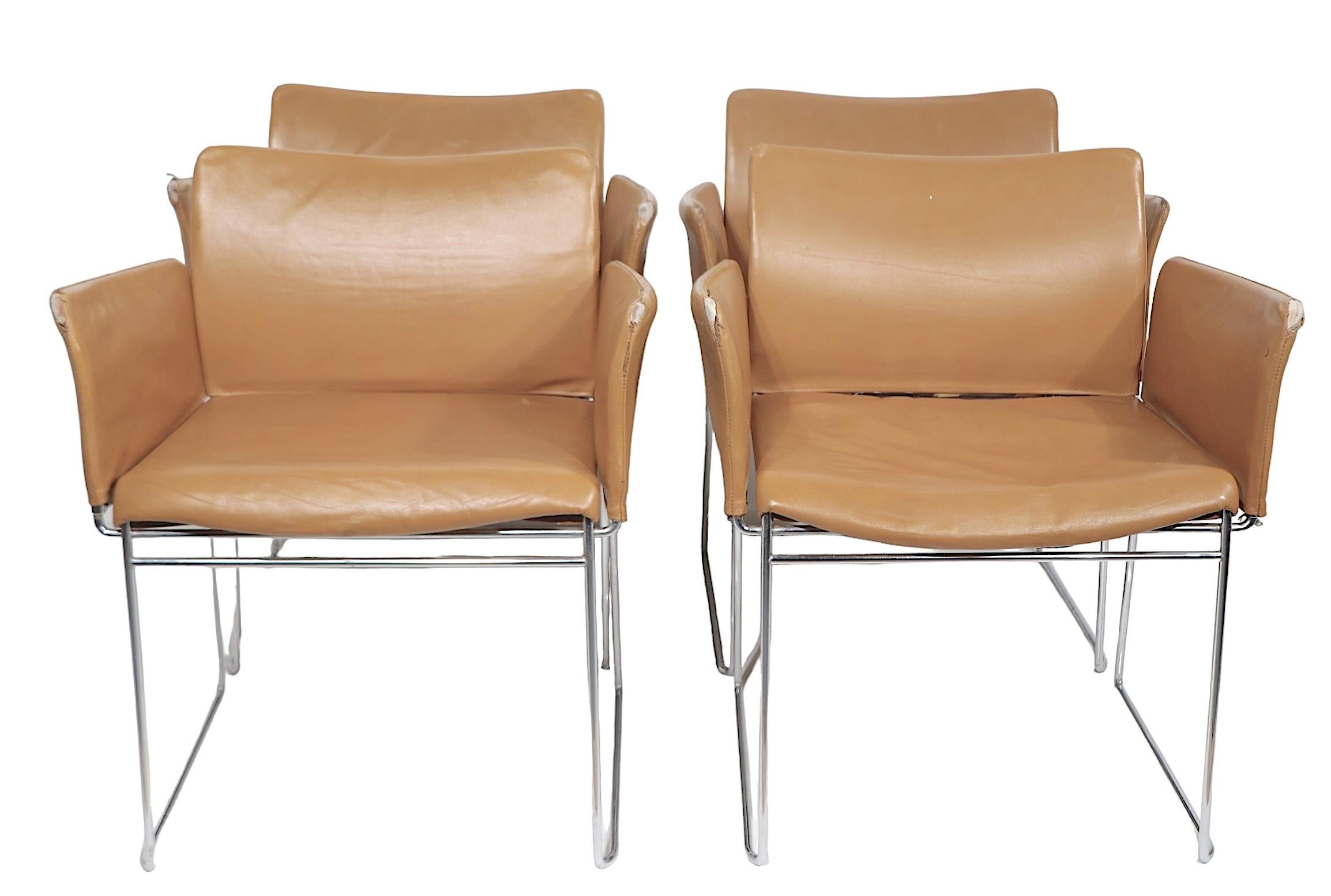 Set of four leather and chrome dining chairs designed by Kazuhide Takahama for Cassina circa 1960-1970's. The chairs feature leather seats, arm rests and backs, on bright chrome frames. The leather shows significant wear, and is selling in as is
