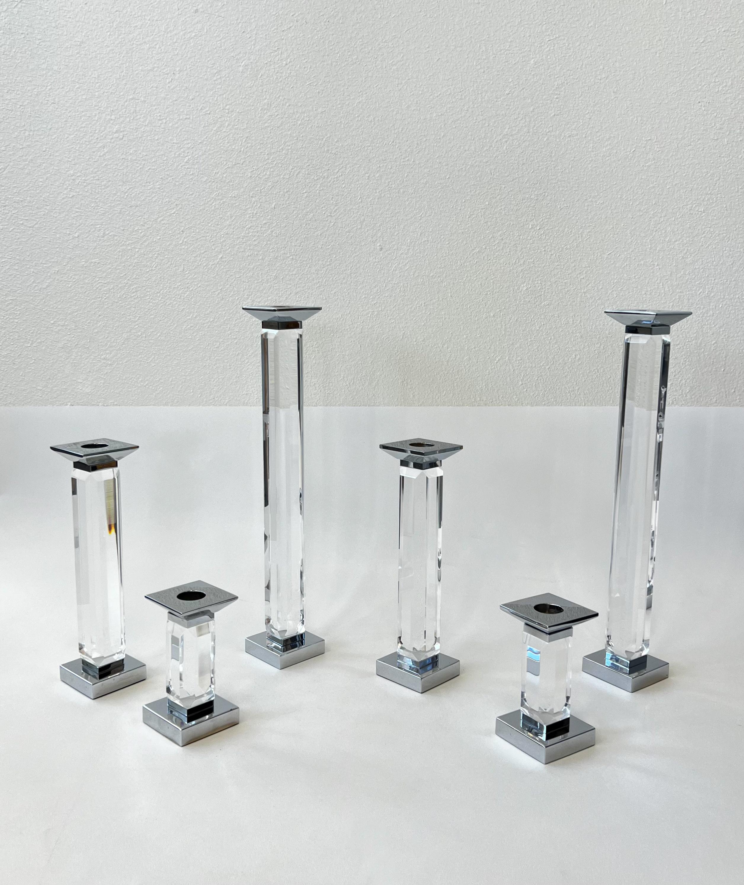 Glamorous set of six clear lucite and chrome candle holders by renowned American designer Charles Hollis Jones. 
In original vintage condition shows minor wear consistent with age. One of the the tallest has a signature label by CHJ. 

Measurements: