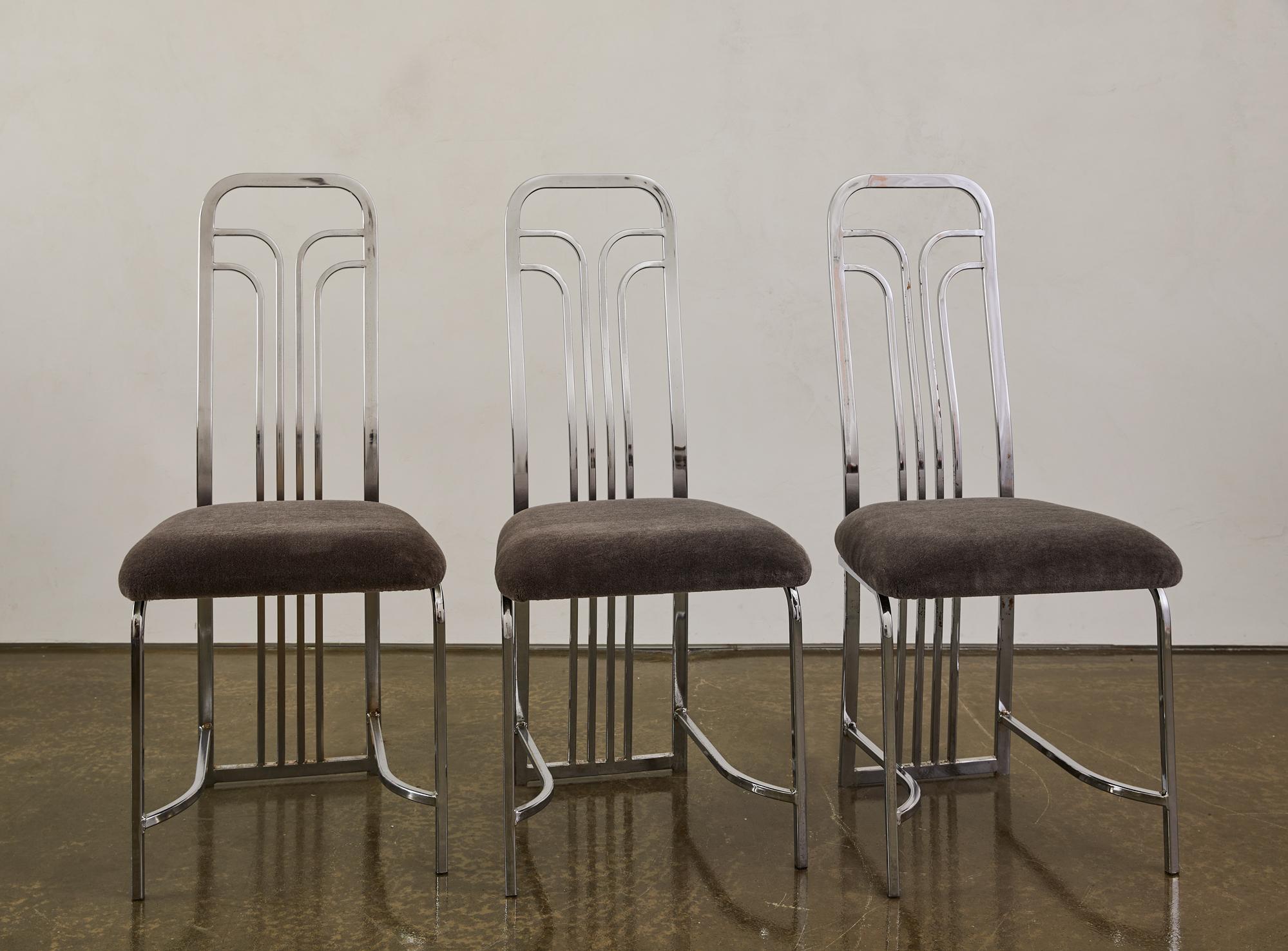 This set of 6 Art Deco revival dining chairs circa 1980s with a vintage chrome finish and newly upholstered gray mohair seats. There is wear to the chrome finish commensurate with age. Chairs can be purchased in sets of two or as a complete set.
