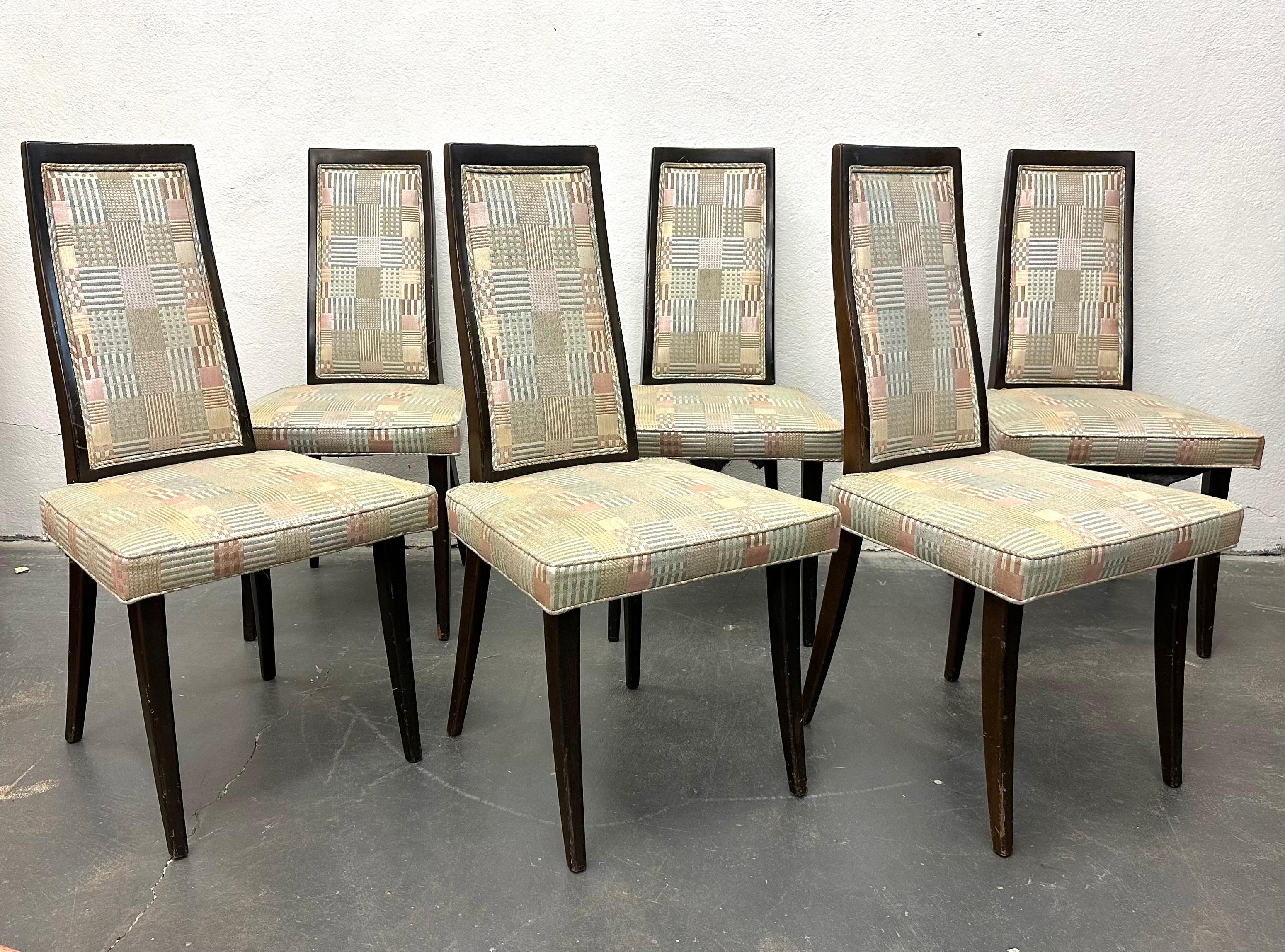 Set of six model 1055 side chairs, in dark stained mahogany with padded  back and seat upholstered in a vintage patchwork fabric. 