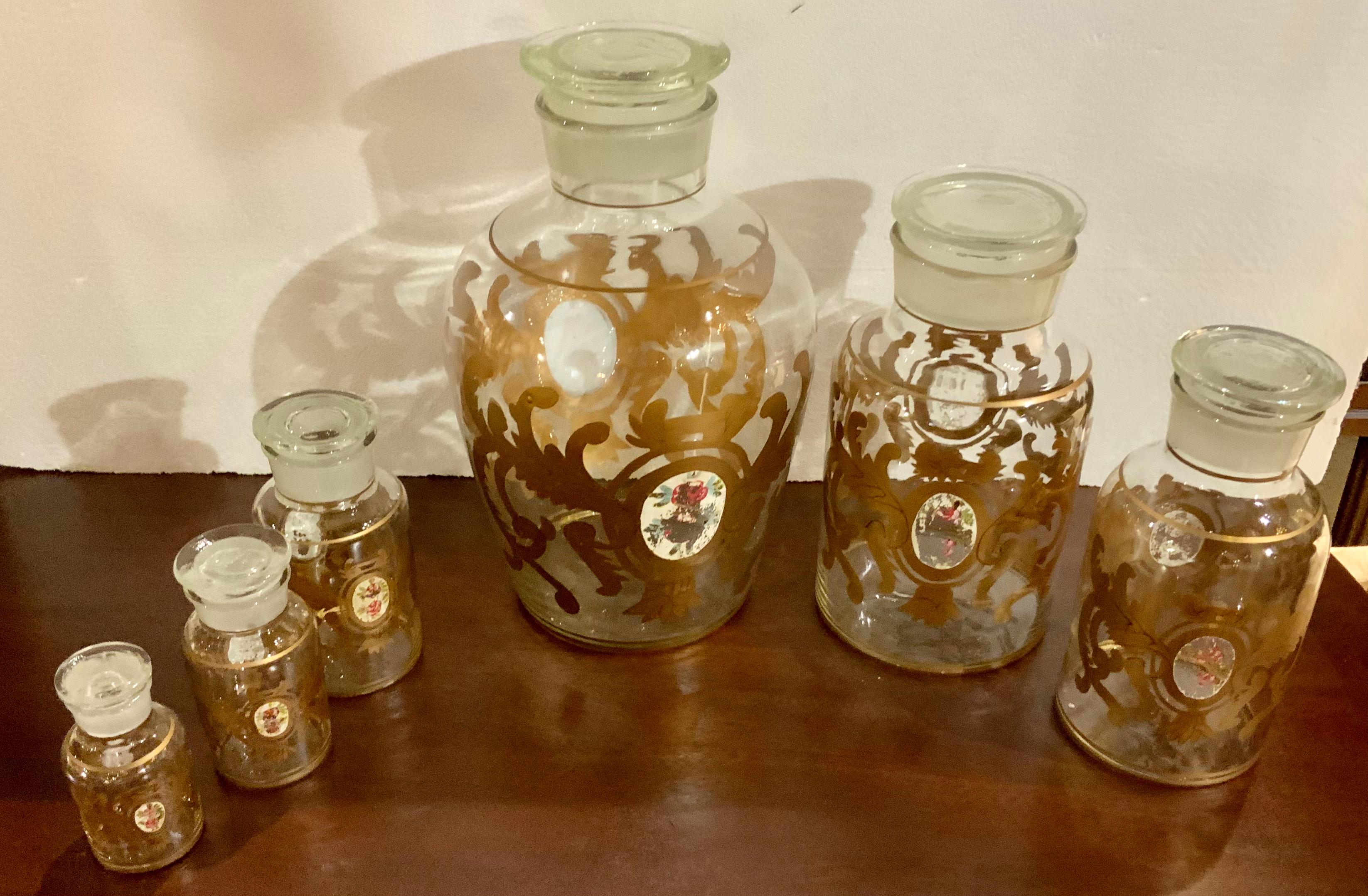 This set is unique because it is a complete set of six hand blown
Apothecary jars with their lids. No breaks or missing pieces!
The gold design encompasses the round shape and a cameo.
With rose design is centered on the front.