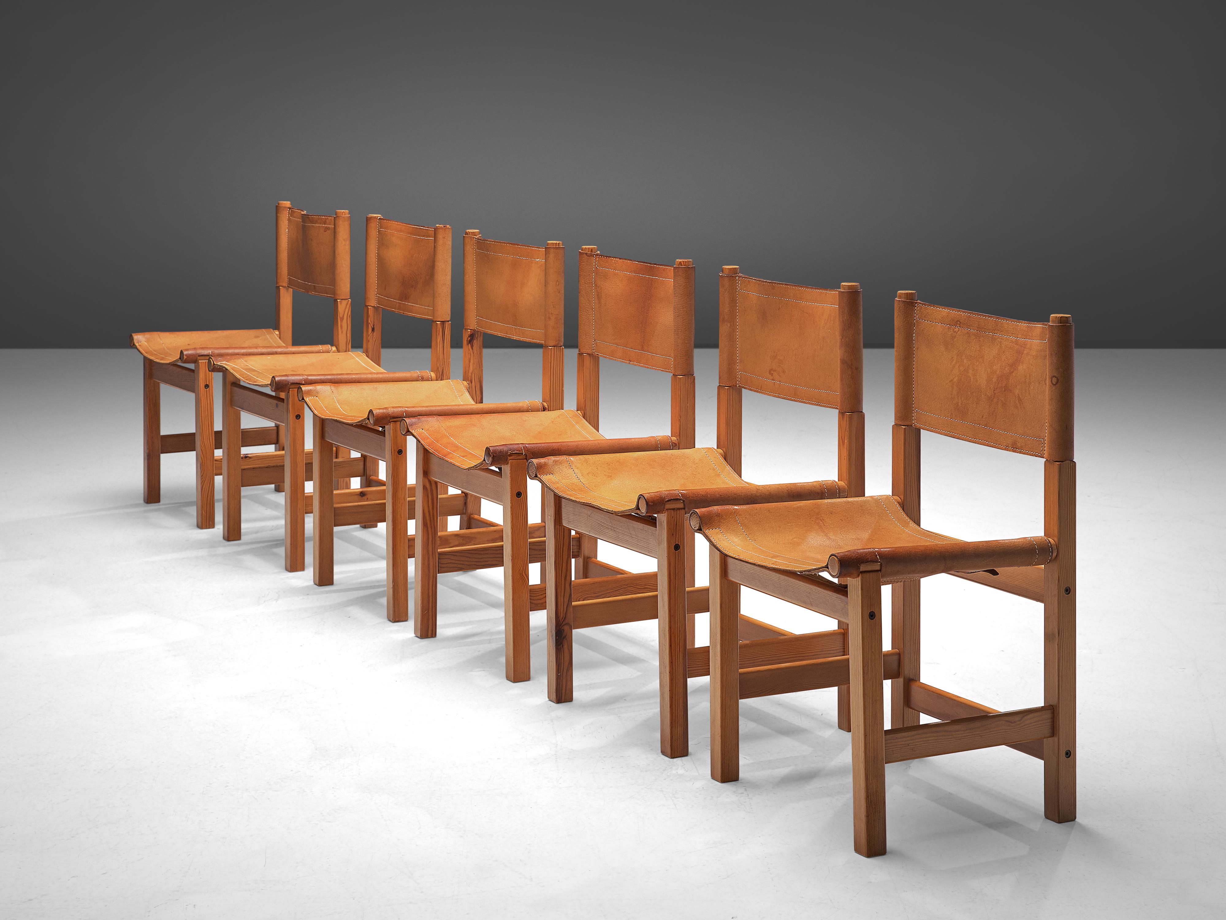 Set of six dining chairs, leather, pine, France 1960s

These French dining chairs show a basic design with straight lines, and a sincere construction in pine wood. The cognac leather seats and backs provide a pleasant comfort, and show nice stitches