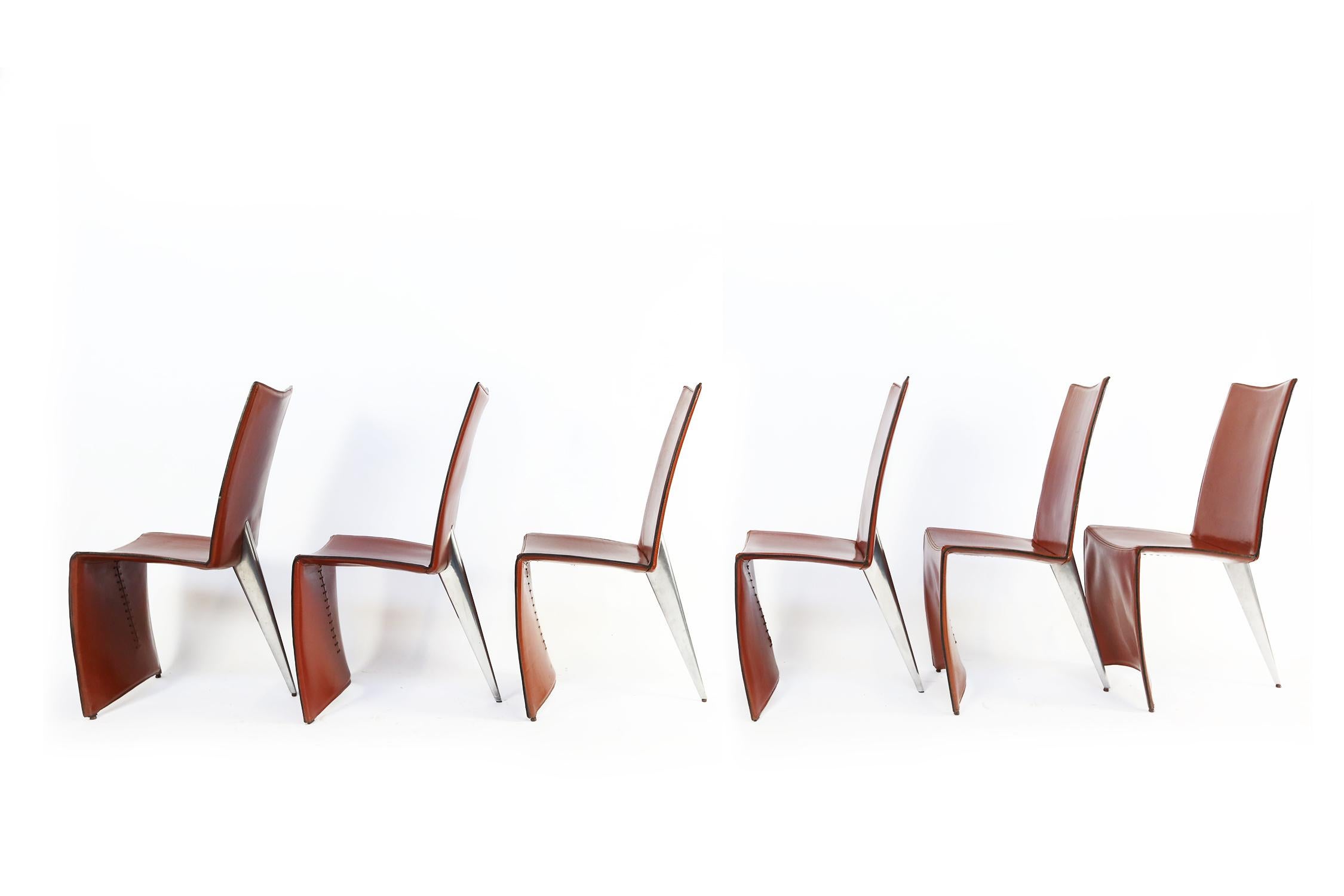 The Ed Archer dining chair was designed by Philippe Starck in 1986 for Driade/ Aleph. The cognac leather “full dress”, that reaches the floor, strongly opposes to the only polished metal “shark finned” back leg.
It is a strong design executed in