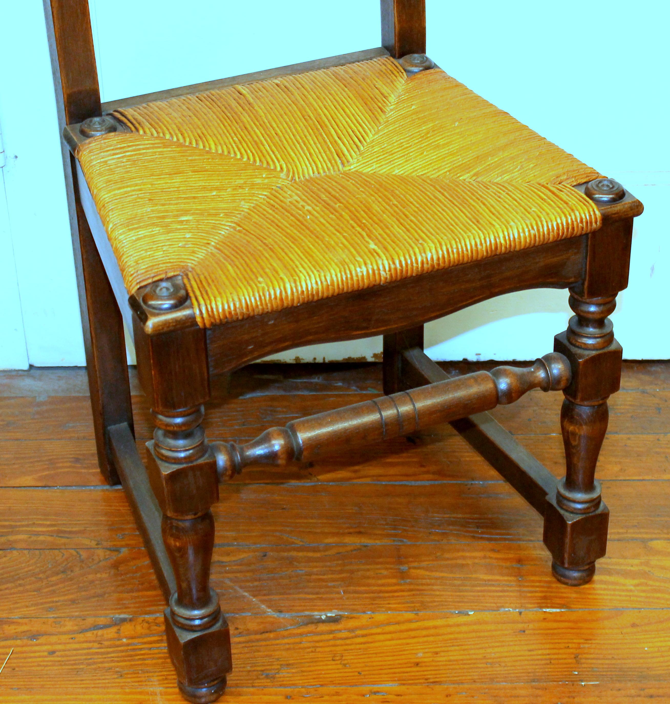 Set of six antique French hand-carved solid oak rush seated dining chairs.