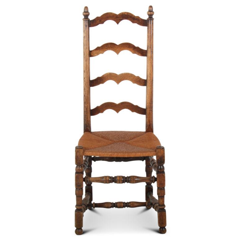 A set of six country French ladder back chairs with rush seats, circa 1920.


  