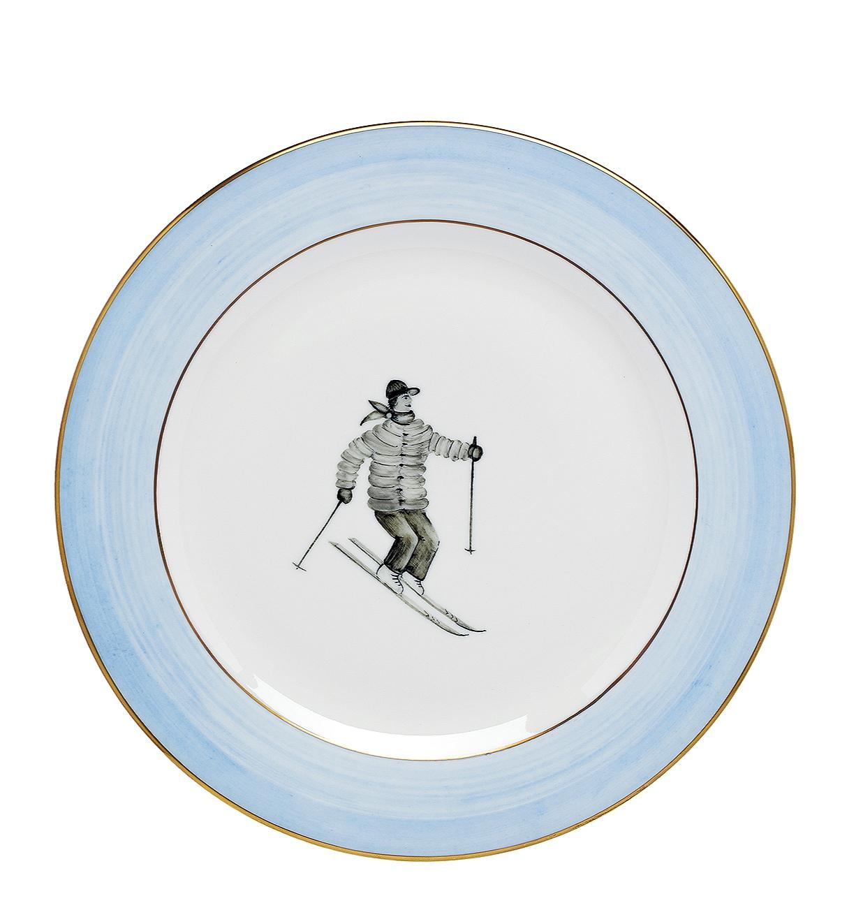 Ensemble de six assiettes à déjeuner en porcelaine sous glaçure, entièrement faites et peintes à la main. Le décor montre un décor de skieur peint en style country avec une ligne mains libres bleue et cerclée de platine. Une assiette plate et une