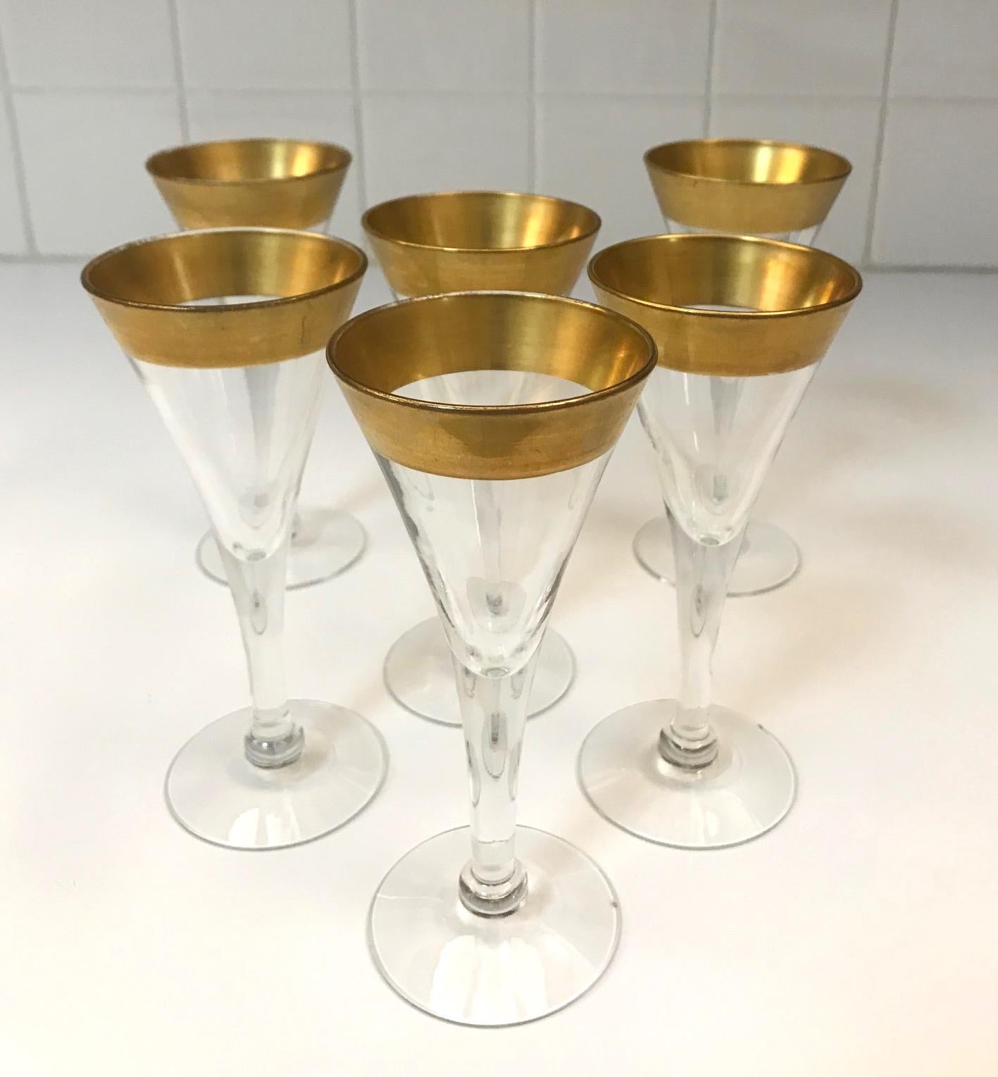 Set of six elegant barware glasses for cordials by iconic midcentury designer Dorothy Thorpe. Rare set features hand blown glass with tapered stems in the form of petite goblets, and with 24-karat gold trim accents. Makes a chic and elegant addition