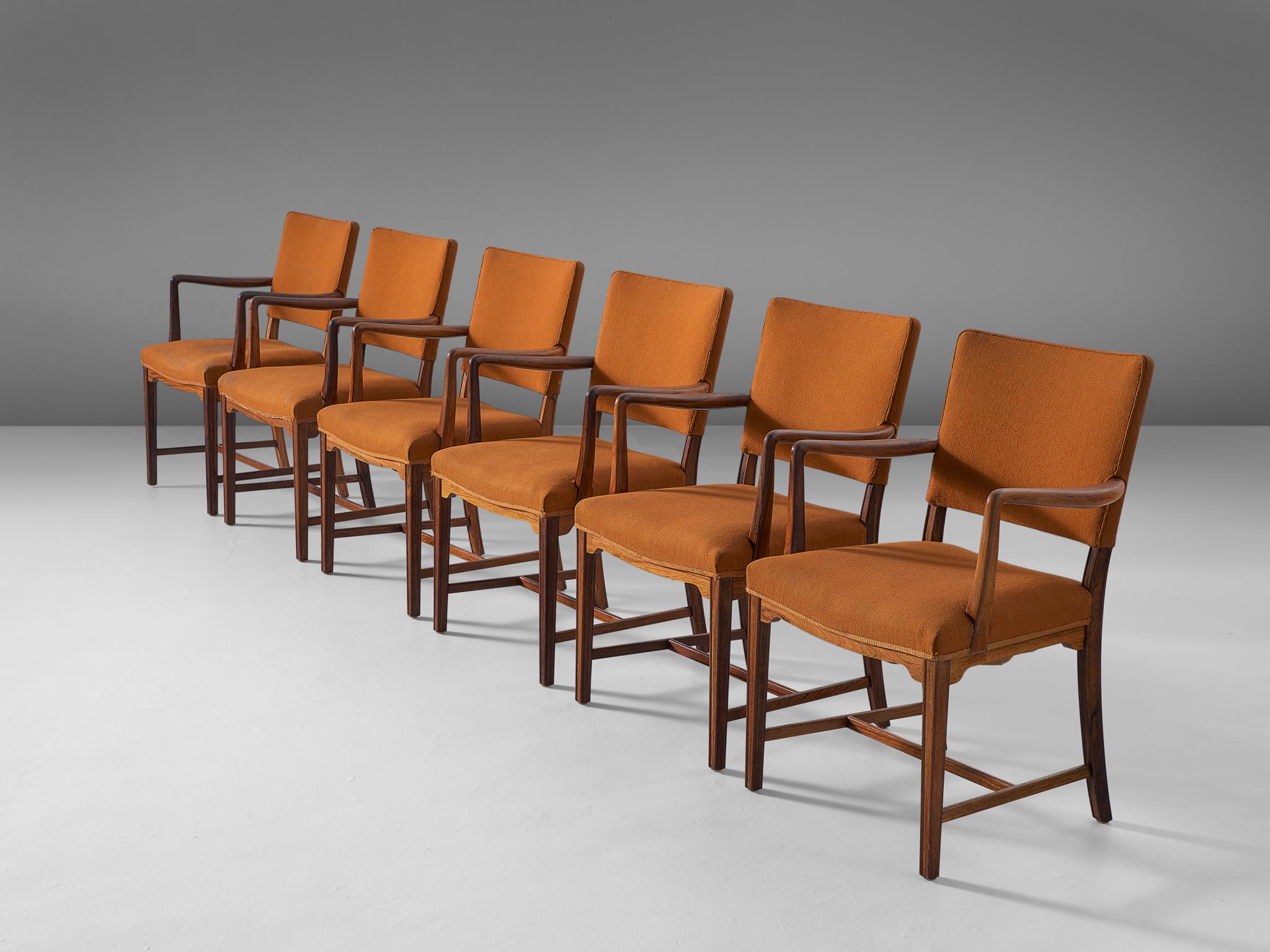 Set of six armchairs, in fabric and rosewood, Denmark, 1940s.

Set of six elegant dining chairs in rosewood and orange fabric upholstery. These chairs show a combination of classical 18th century chairs with Danish modern. The characteristics of Ole