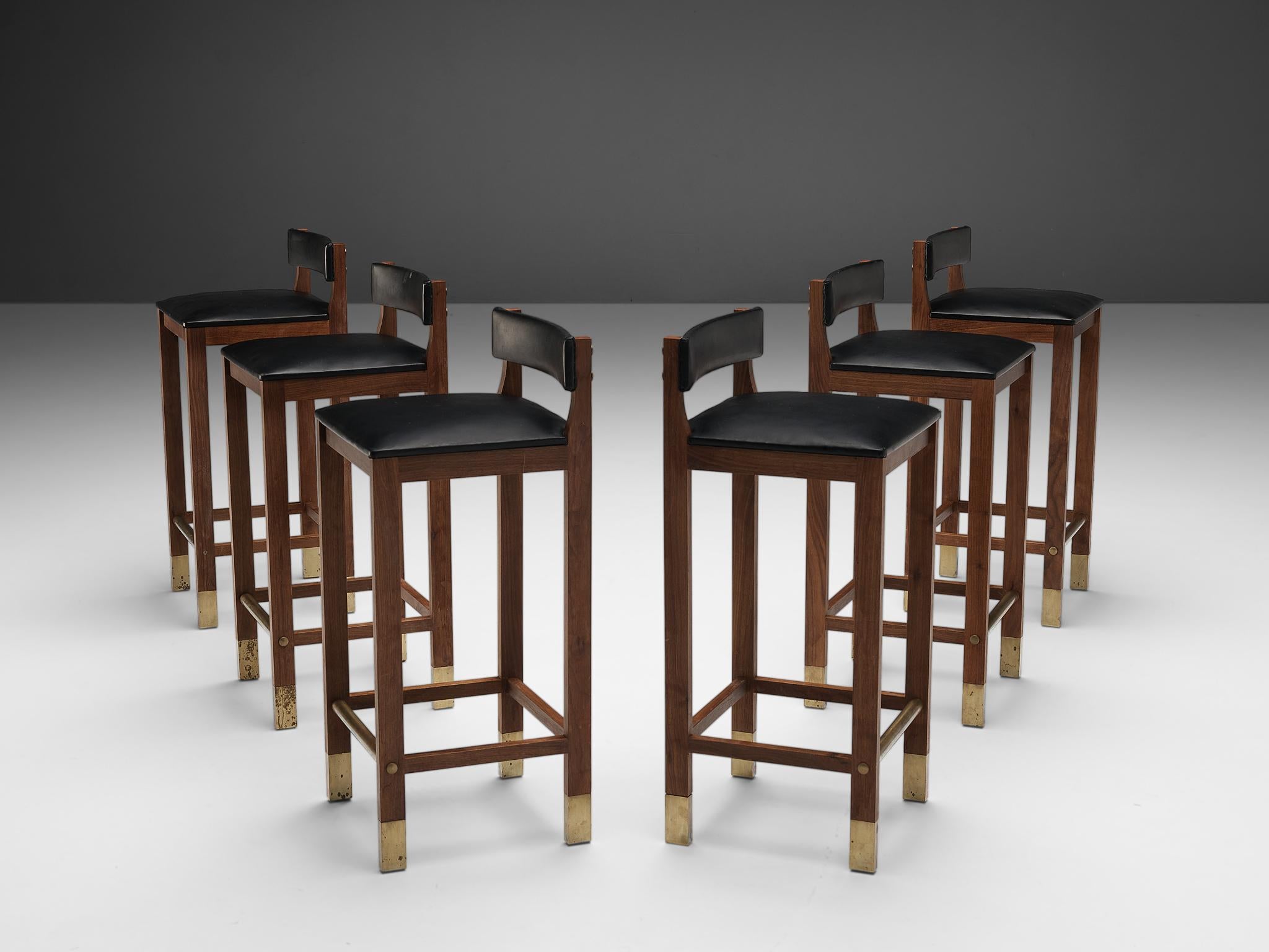 Set of six Danish bar stools, teak, brass, leatherette, Denmark, 1960s

This set of six Danish bar stools shows a strong design that features brass feet on the teak frame as well as a brass footrest and black leatherette upholstered seats. The seat