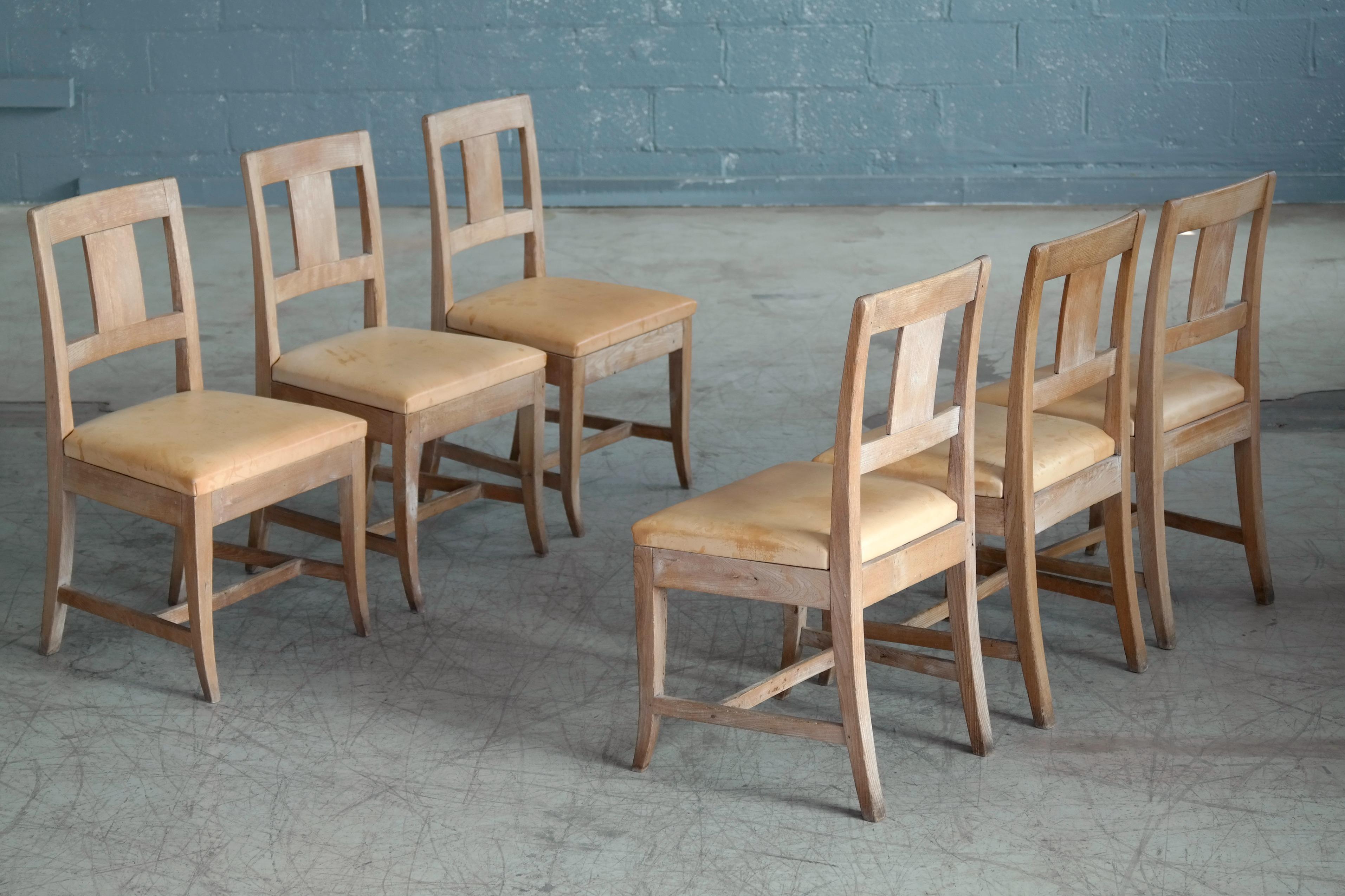 A great set of six dining chairs carved in elmwood in the English empire style and made in Denmark around 1900. The chairs have no ornamentation and are just beautifully simplistic. The chairs show plenty of natural age wear but remain sturdy and