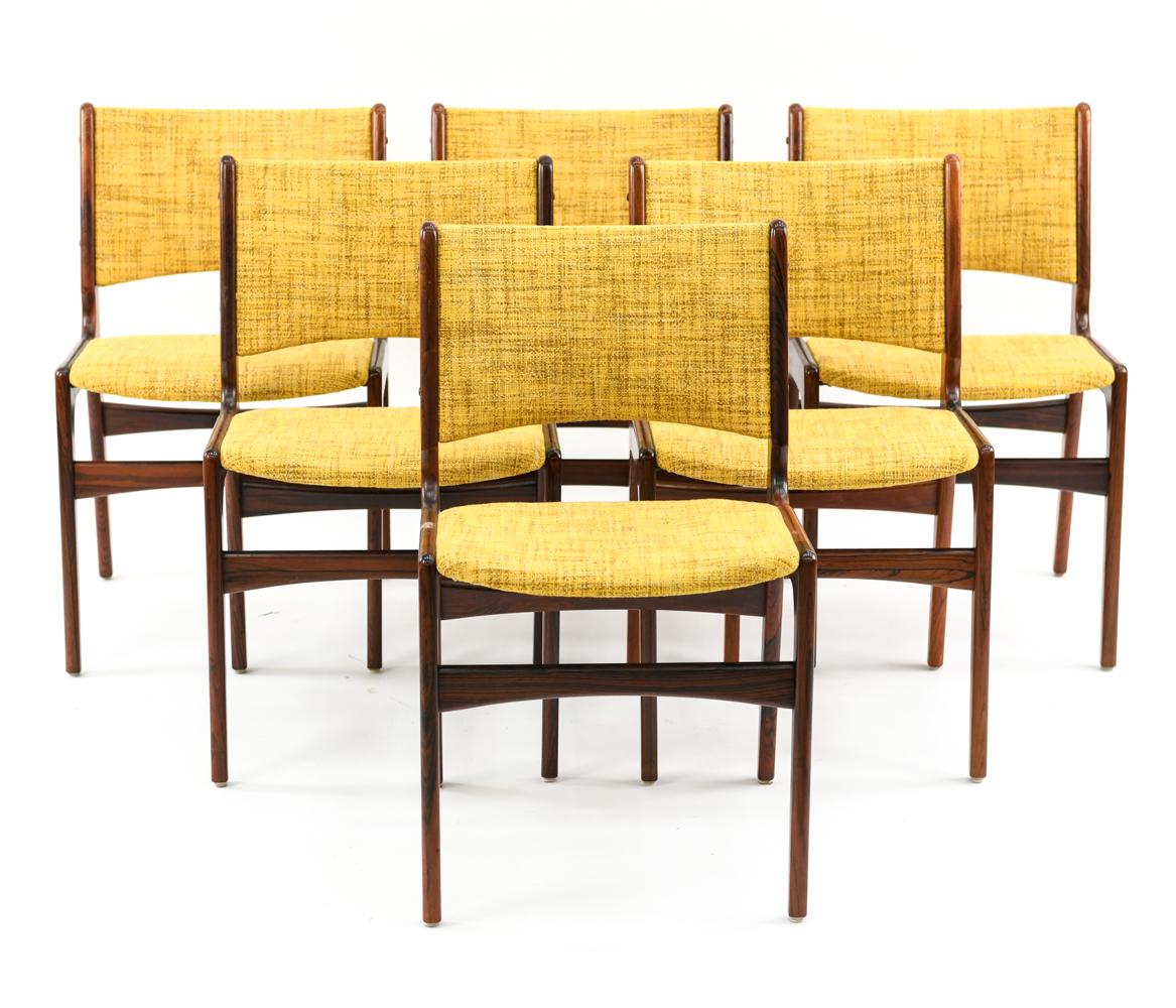 A set of six Danish midcentury dining or side chairs designed by Erik Buck for Odense Maskinsnedkeri, circa 1950s. A great Scandinavian Modern aesthetic with attractive curves and angles that appeal from all sides.