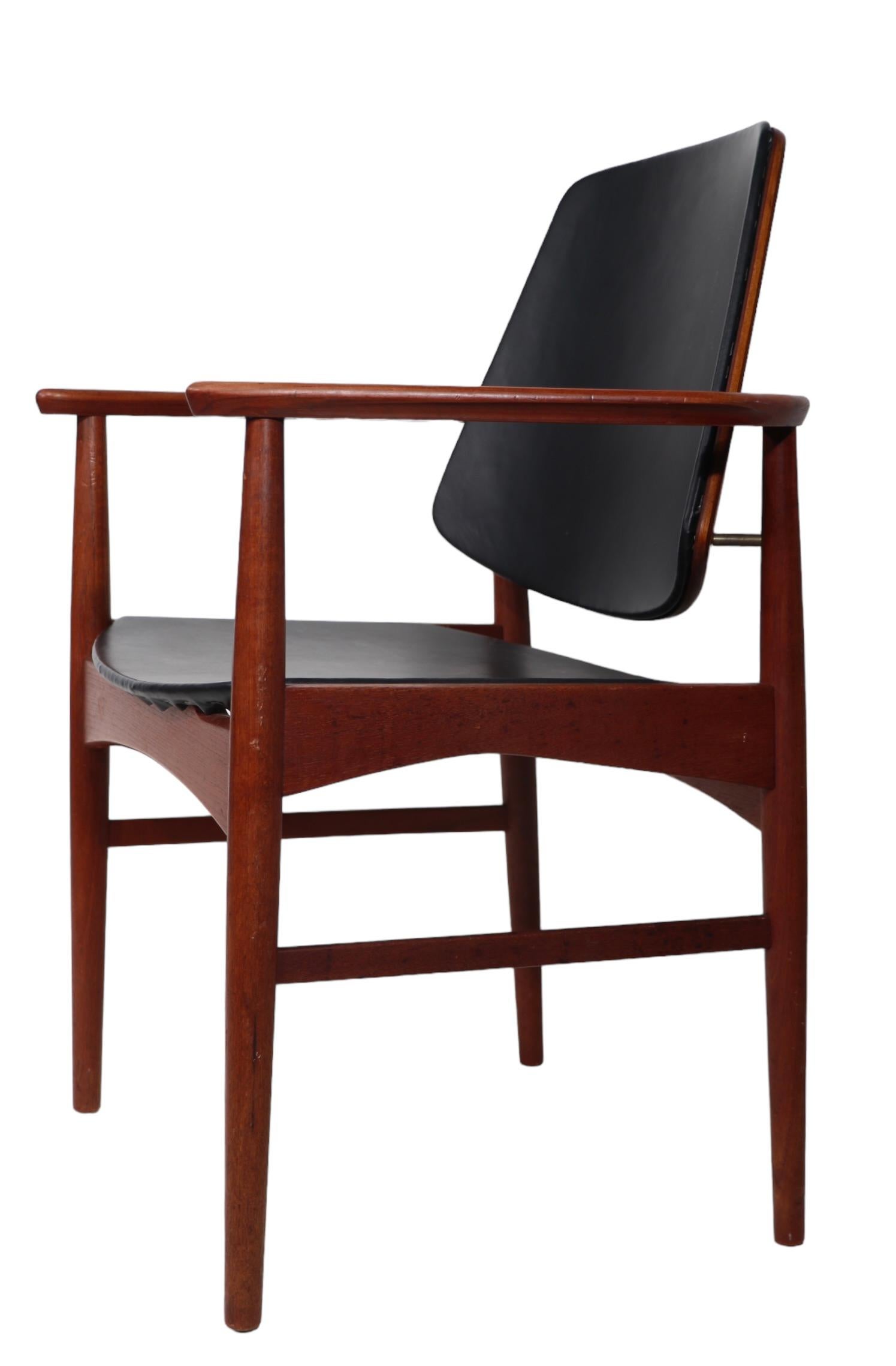Set of six Danish Mid Century Modern dining chairs, constructed of solid teak with black vinyl seats and back rests. The set consists of four side, and two arm chairs - this design is often attributed to Arne Hovmand Olsen, for Onsild  Mobelfabrik,