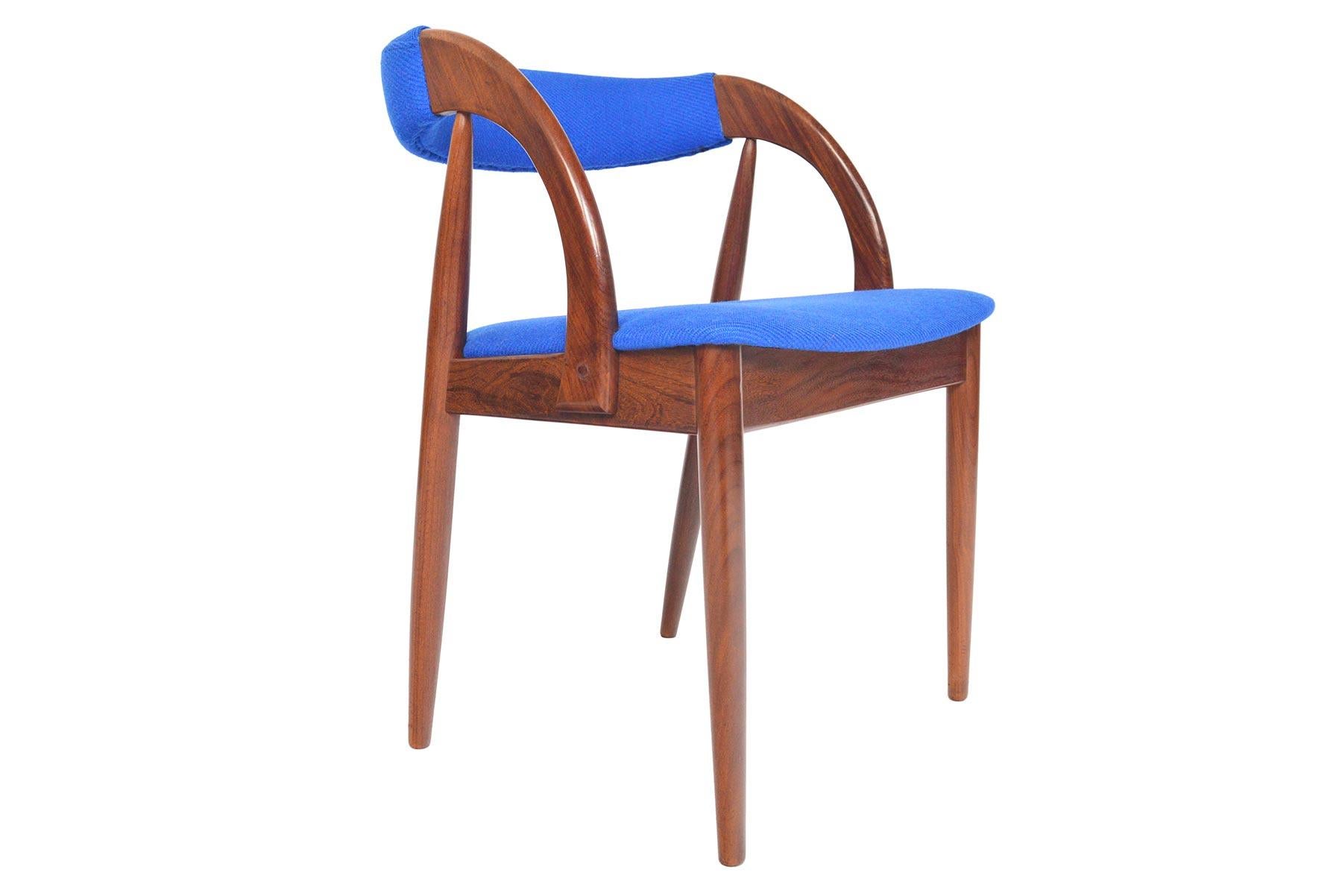 Elegant and exceedingly comfortable, this set of six Danish midcentury walnut dining chairs is the perfect companion for any modern dining room. Sculpted walnut creates a stunning profile from the side and wraps around to offer an upholstered