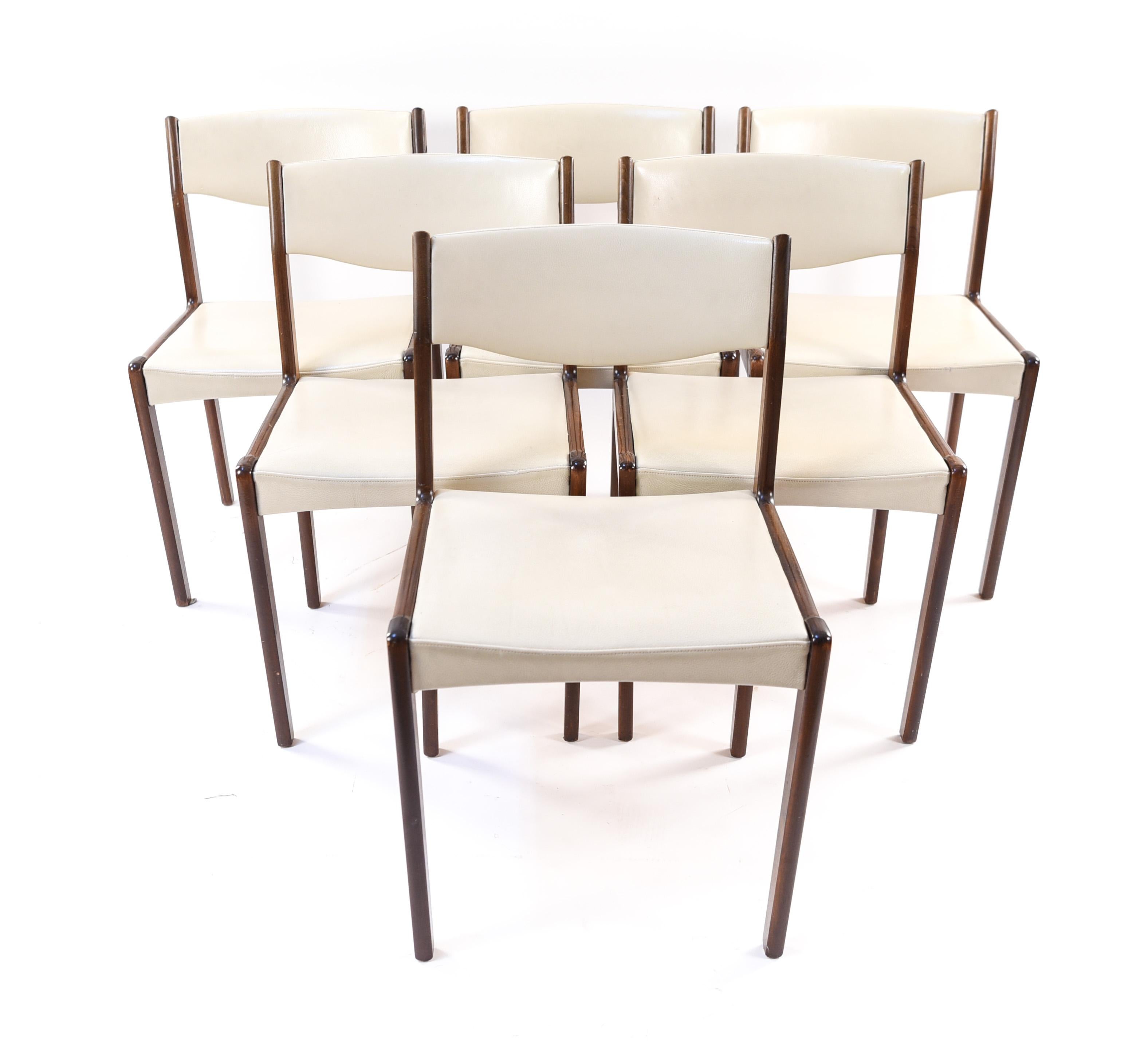 This is a wonderful set of six Danish midcentury dining or side chairs by Sax, circa 1960s. These chairs have a timeless modern design, with rosewood frames and white leather upholstery. Their sleek appearance serves them well to fit around a dining