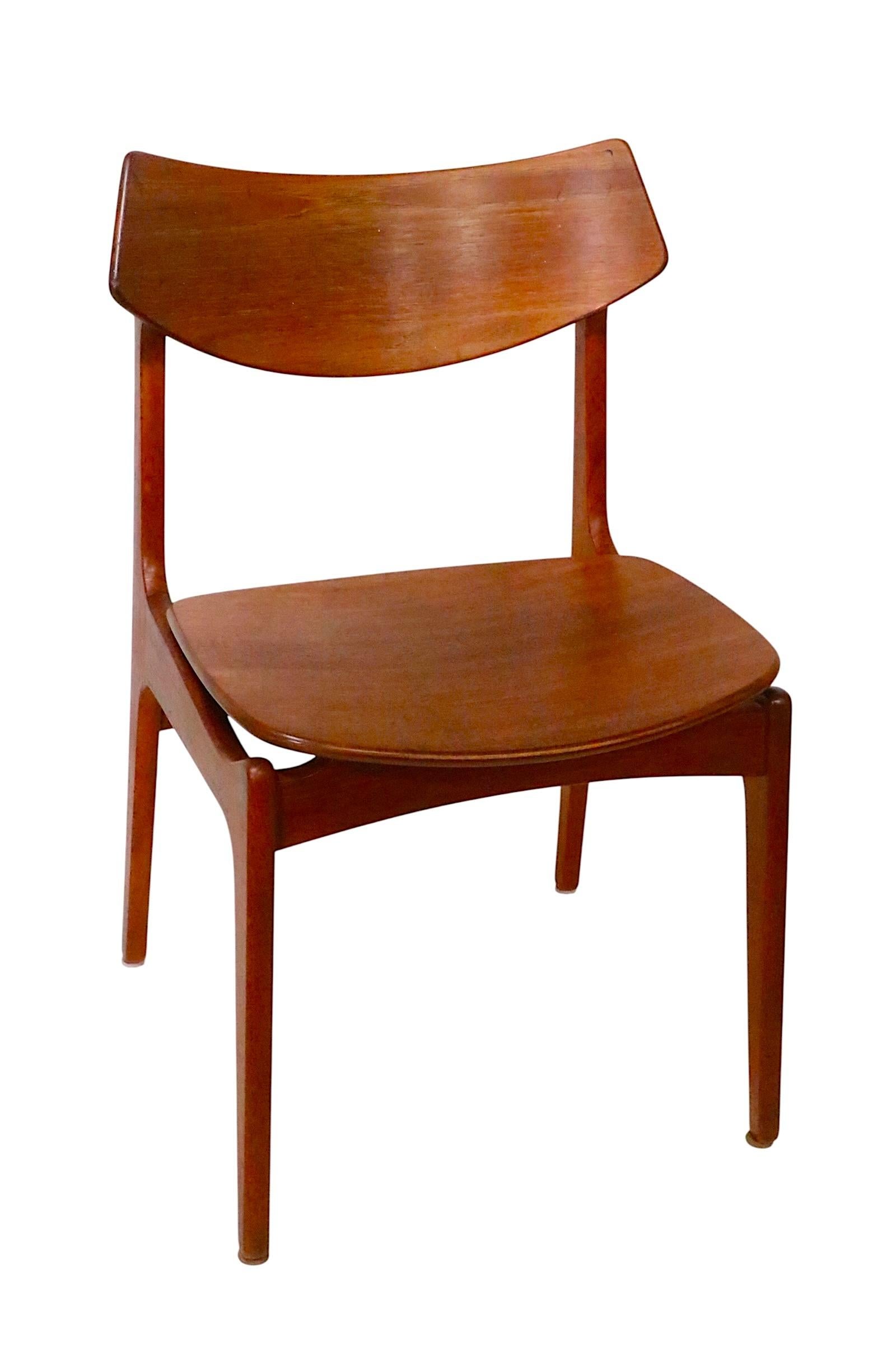 Exceptional set of Danish Mid Century Modern dining chairs, designed by Erik Buch for Funder-Schmidt & Madsen, made in Denmark, circa 1950's. The set consists of six side chairs, constructed of solid teak, and teak veneer. All six are structurally