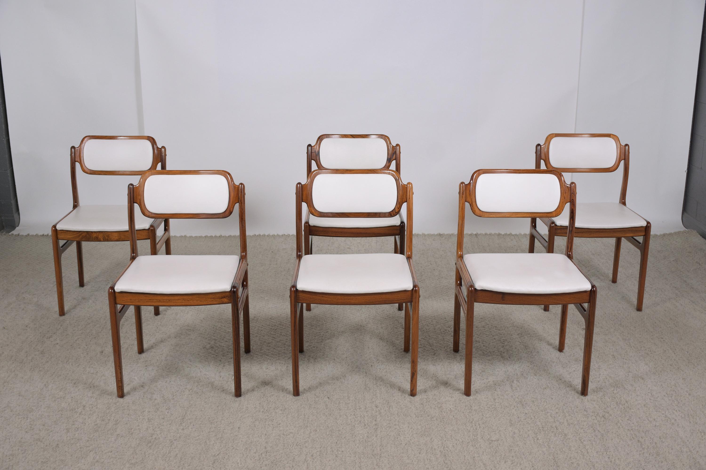 An extraordinary set of six danish modern dining chairs beautiful crated out rosewood in great condition completed restored by our professional craftsmen team. This fabulous vintage set of chairs features a solid sturdy carved frame stained in