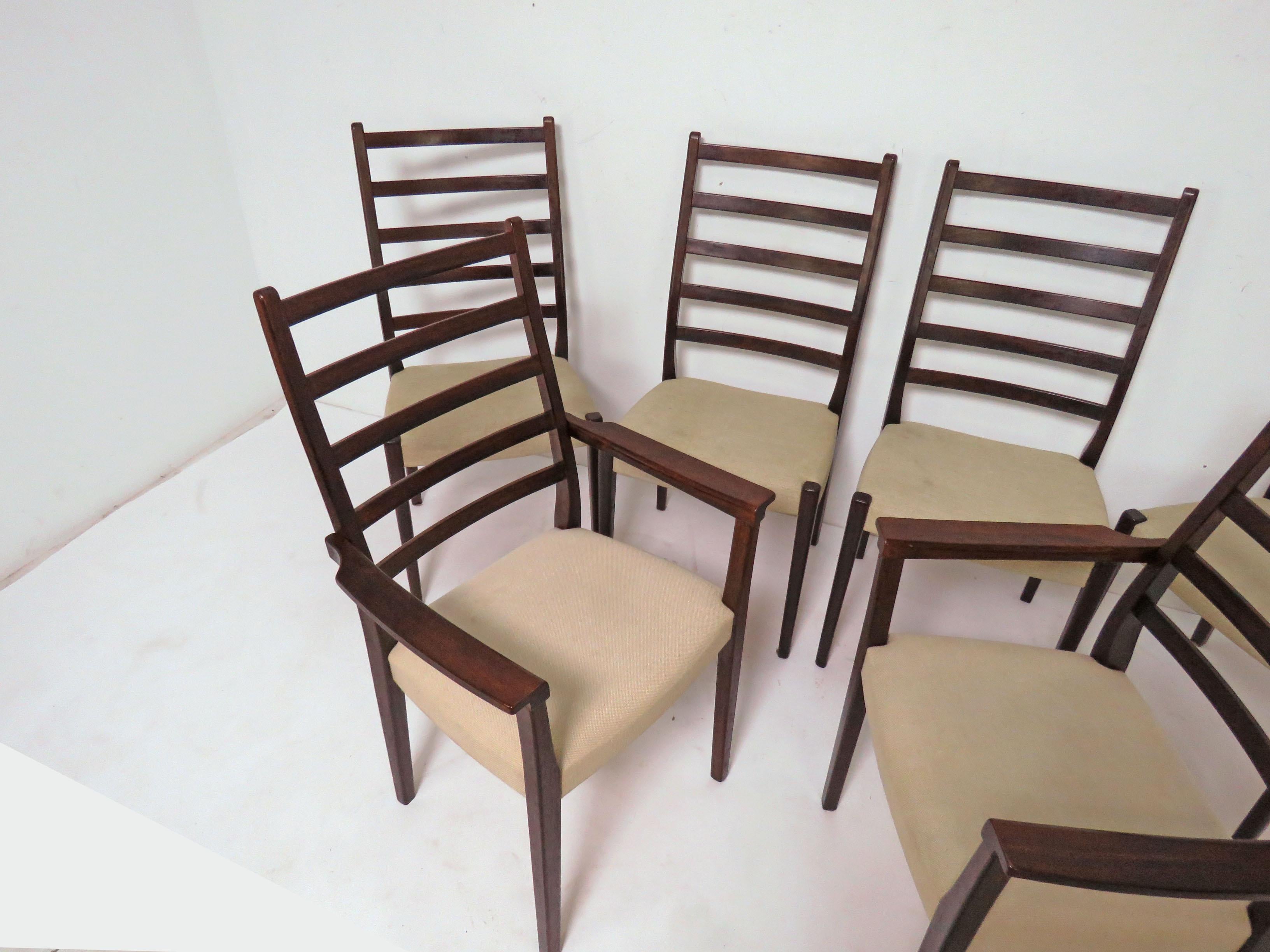 Set of six elegant rosewood ladder back dining chairs consisting of two-arm and four side chairs by Svegards of Markaryd, made in Sweden, circa 1970s.

Armchairs measure: 21.75