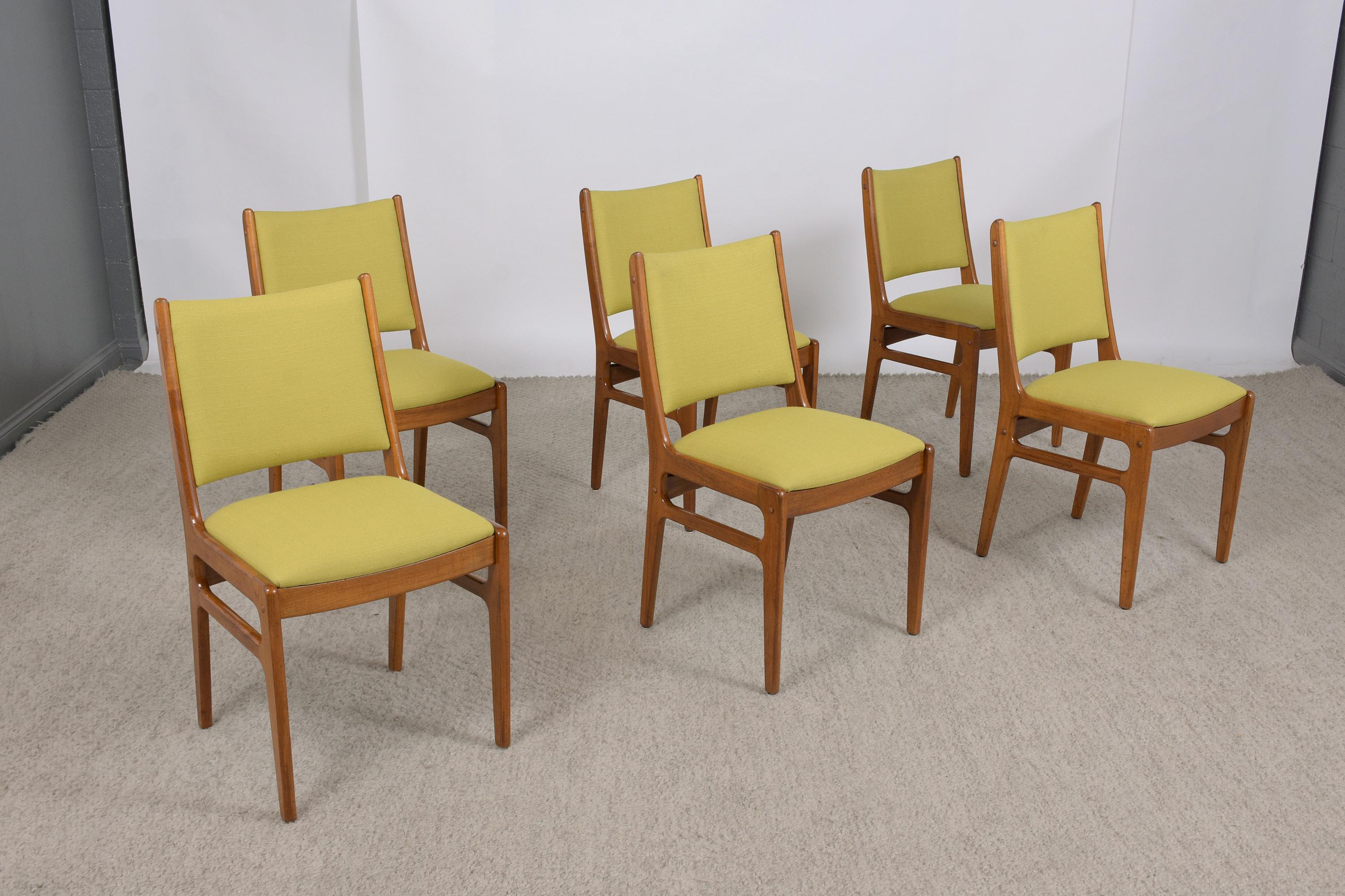 An exceptional set of six mid-century modern dining chairs hand-crafted out of walnut wood in great condition professionally restored by our team of craftsmen. This set of chairs features a sleek carved frame finished in a light walnut color with a