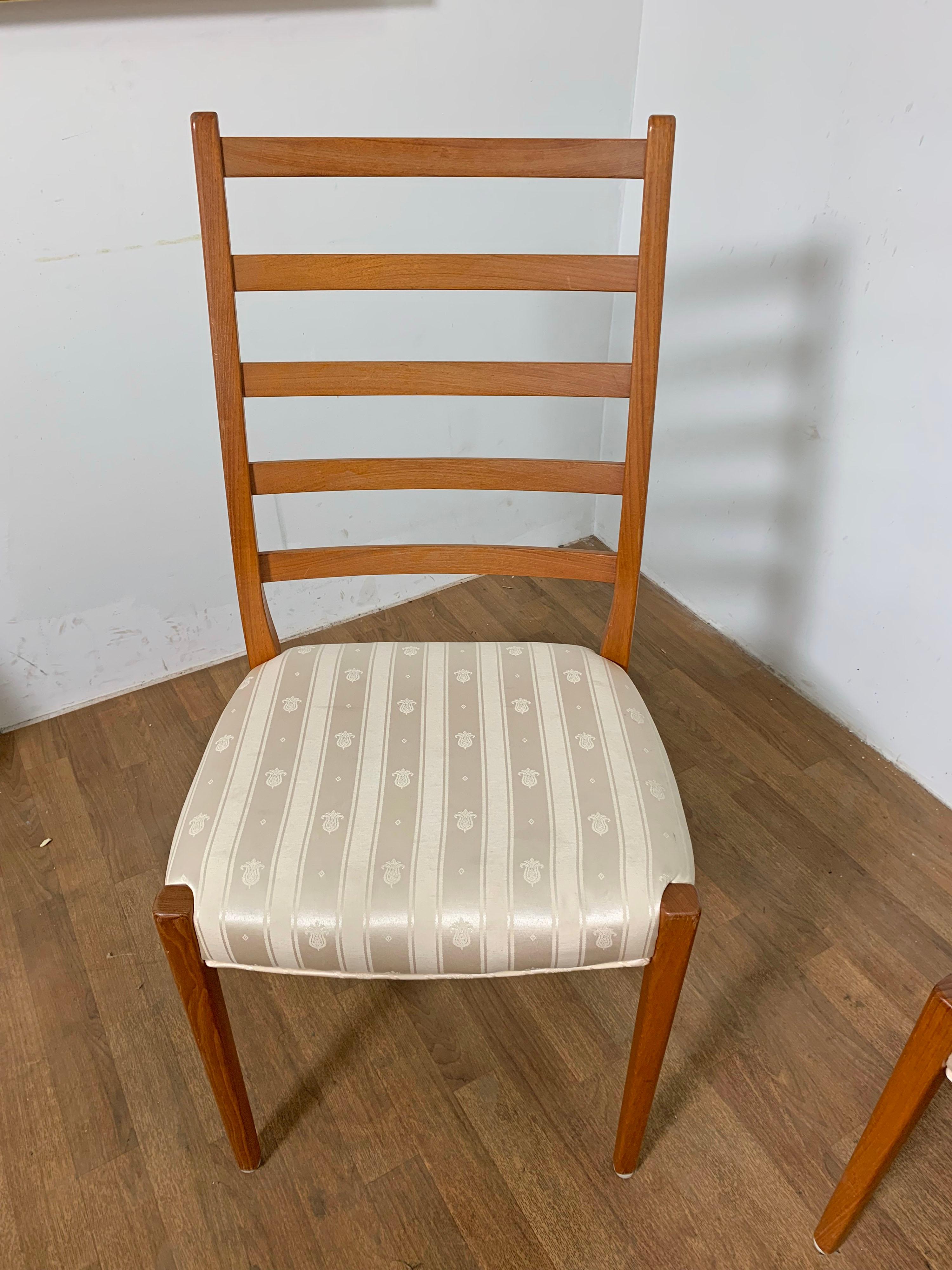 Set of six elegant teak ladder back dining chairs consisting of two-arm and four side chairs by Svegards of Markaryd, made in Sweden, circa 1970s.

Armchairs measure: 21 7/8