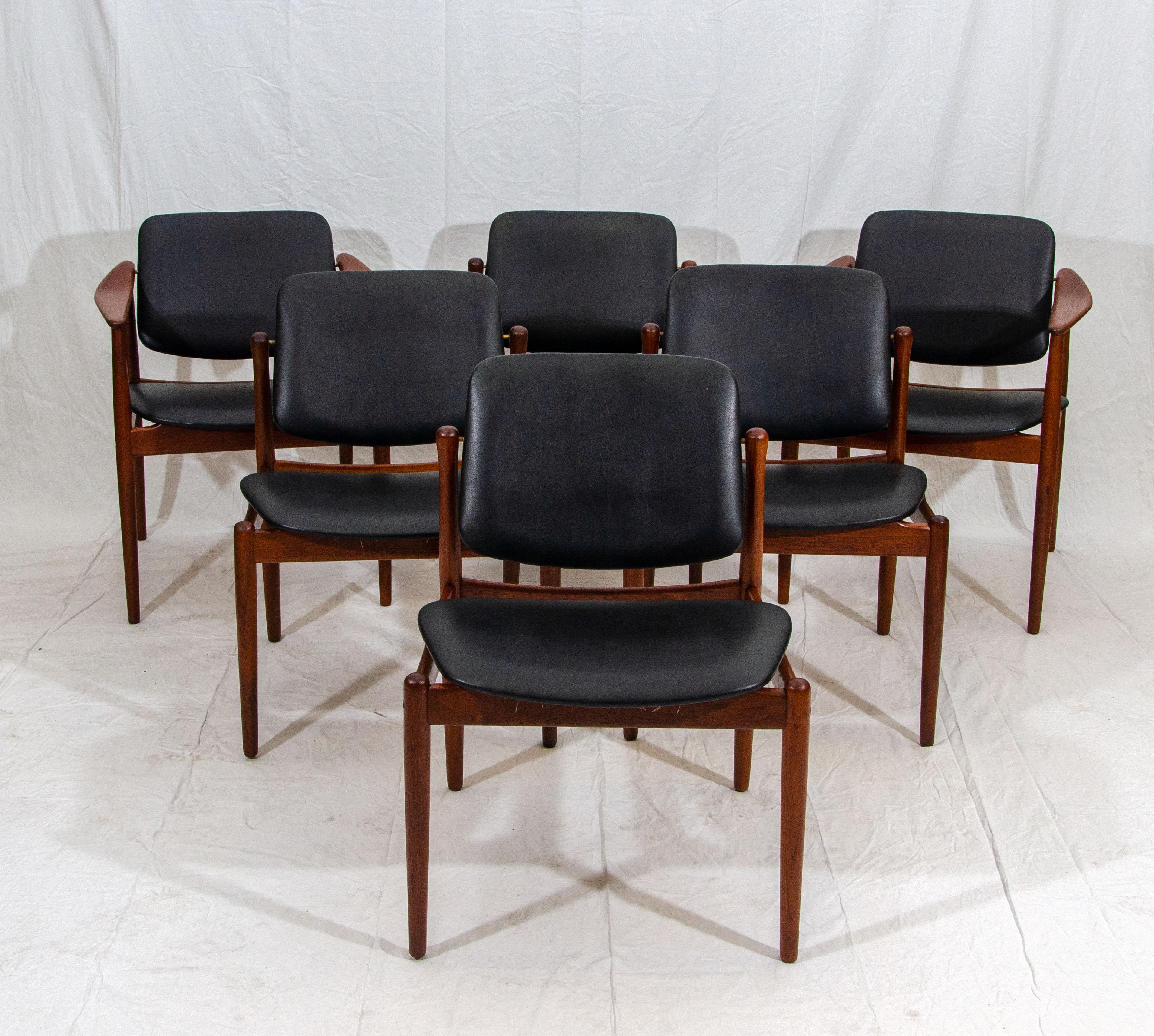 Seldom seen a set of unusual Danish teak dining chairs manufactured by Bovirke (model BO92) and designed by Arne Vodder. The backs tilt for comfortable seating and the black faux leather upholstery is original with a few very minor imperfections too