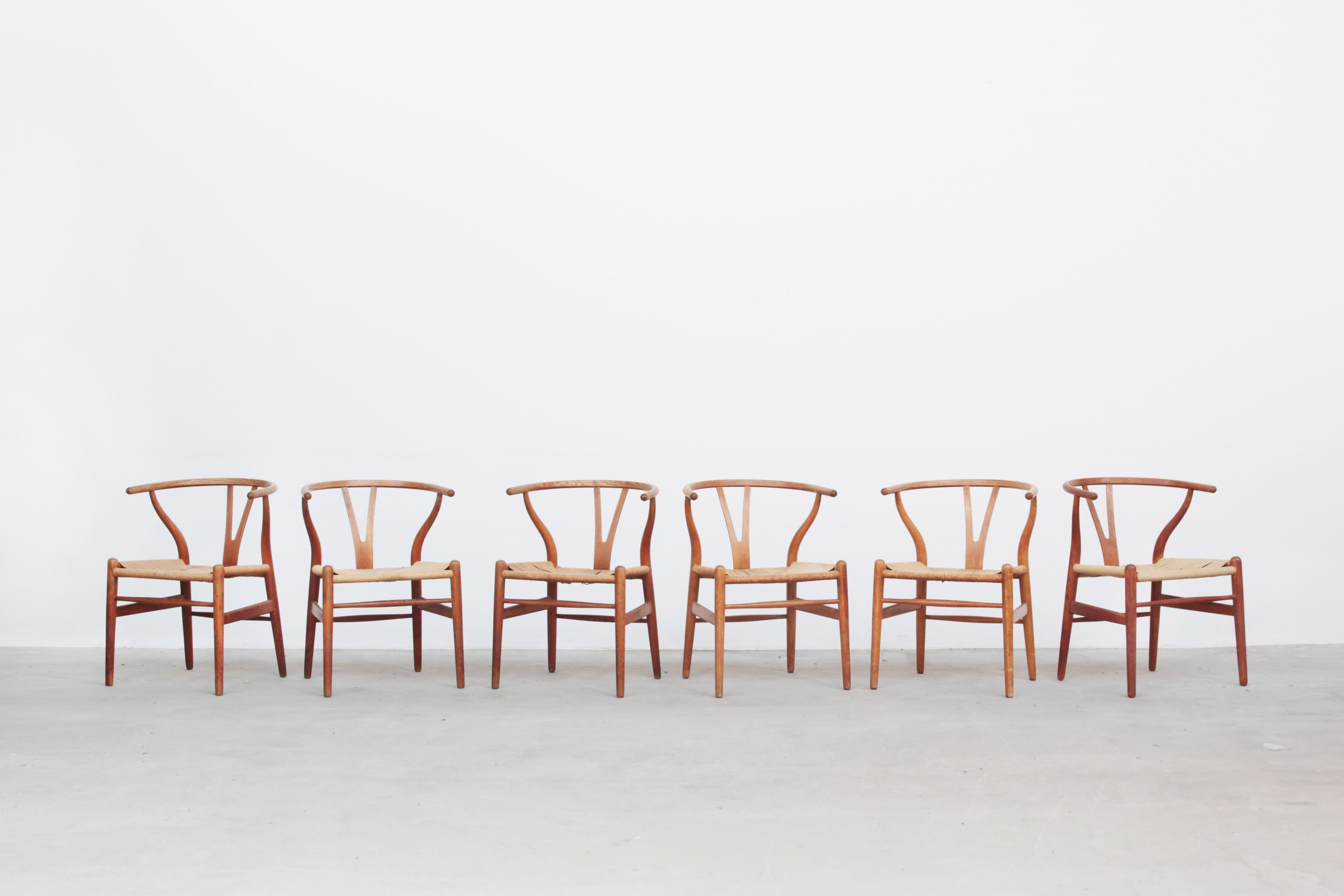 A set of six beautiful and original wishbone chairs designed by Hans J. Wegner and produced by Carl Hansen in the 1960s in Denmark. All chairs are made out of oak and in a beautiful original condition with signs of usage like little stains, dirt and