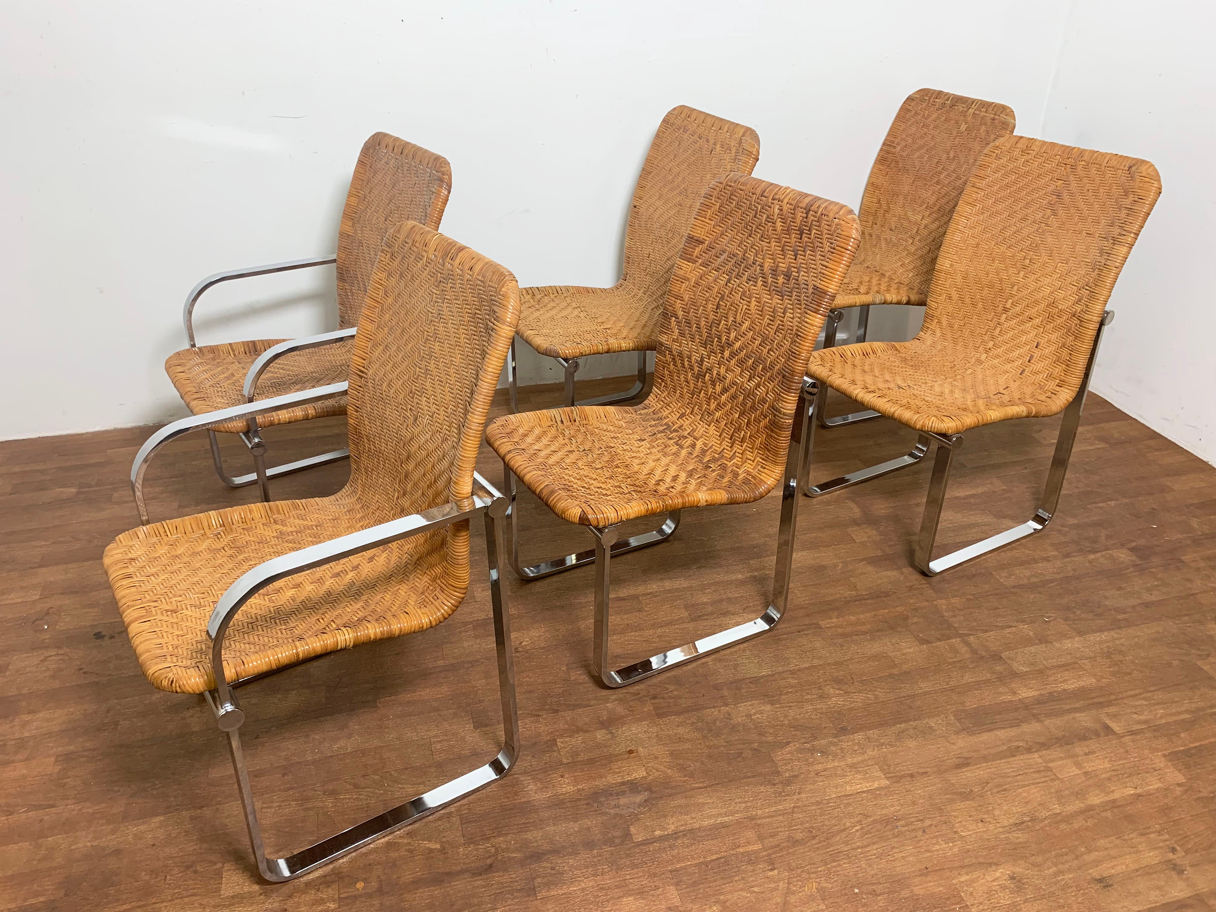 A set of six woven rattan and chromed steel dining chairs by Design Institute America, circa 1970s, consisting of two arm chairs and four side chairs. Often attributed to having been made in Italy for the importer Charles Stendig. However, there is