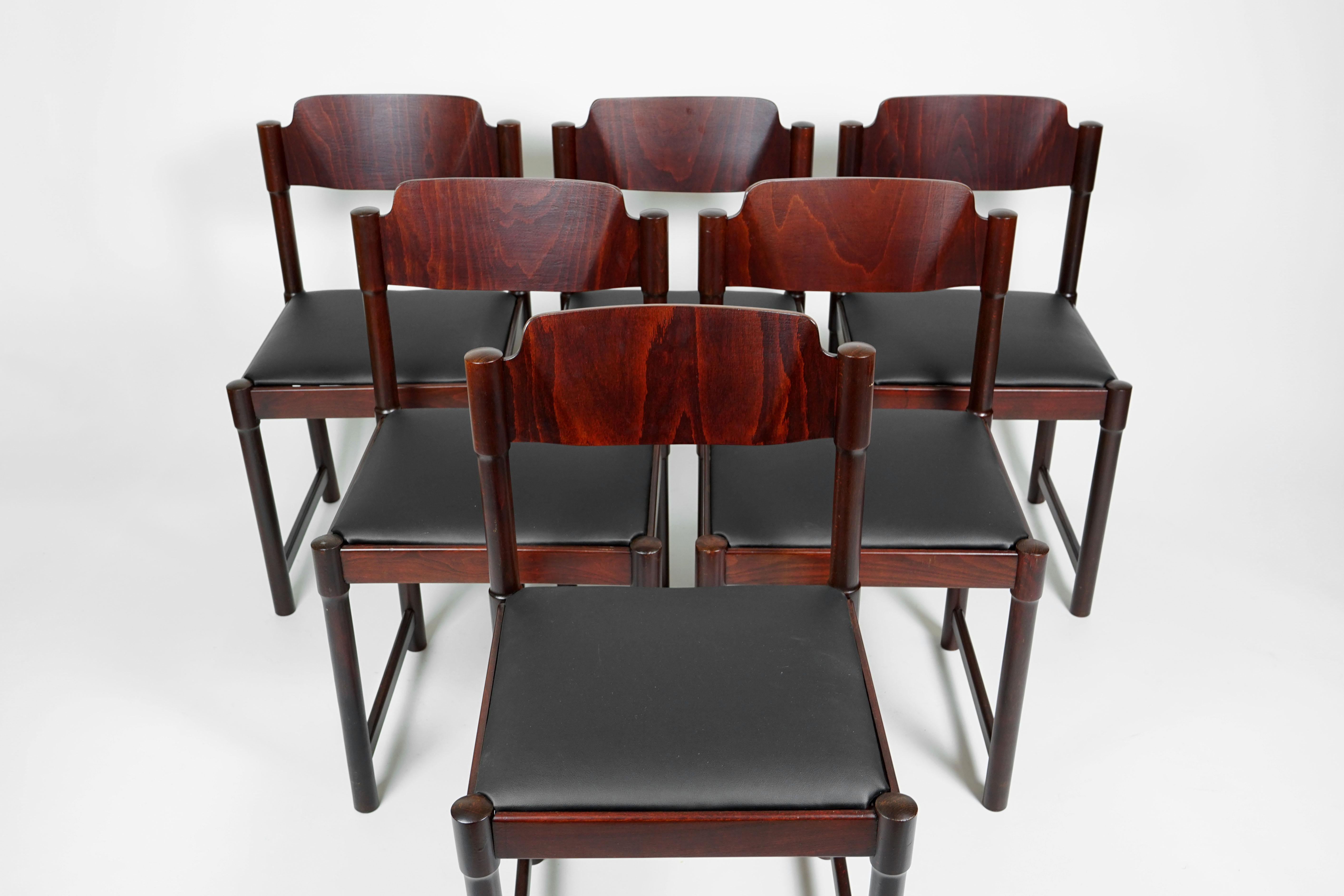 Set of six extraordinary and unique dining room chairs, of Czechoslovakian designer Antonin Suman. Produced in the 1970s.

The chairs are totally restored and mahogany stained. The seating is refurbished with a black high-quality artificial