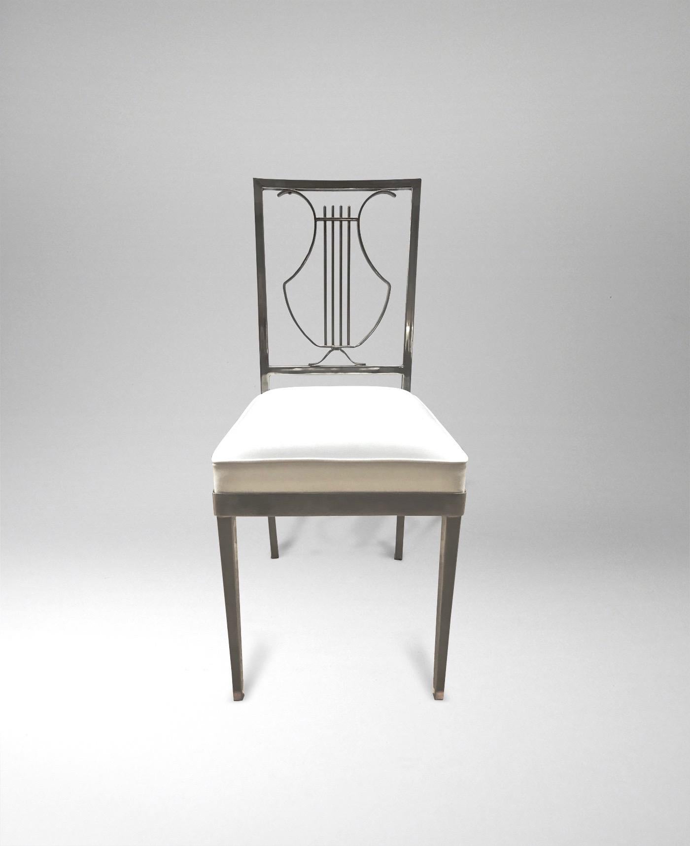 French, 1970s
Each in brushed metal finish, with stylized 'lyre' backrest
Seats re-upholstered in white faux leather.