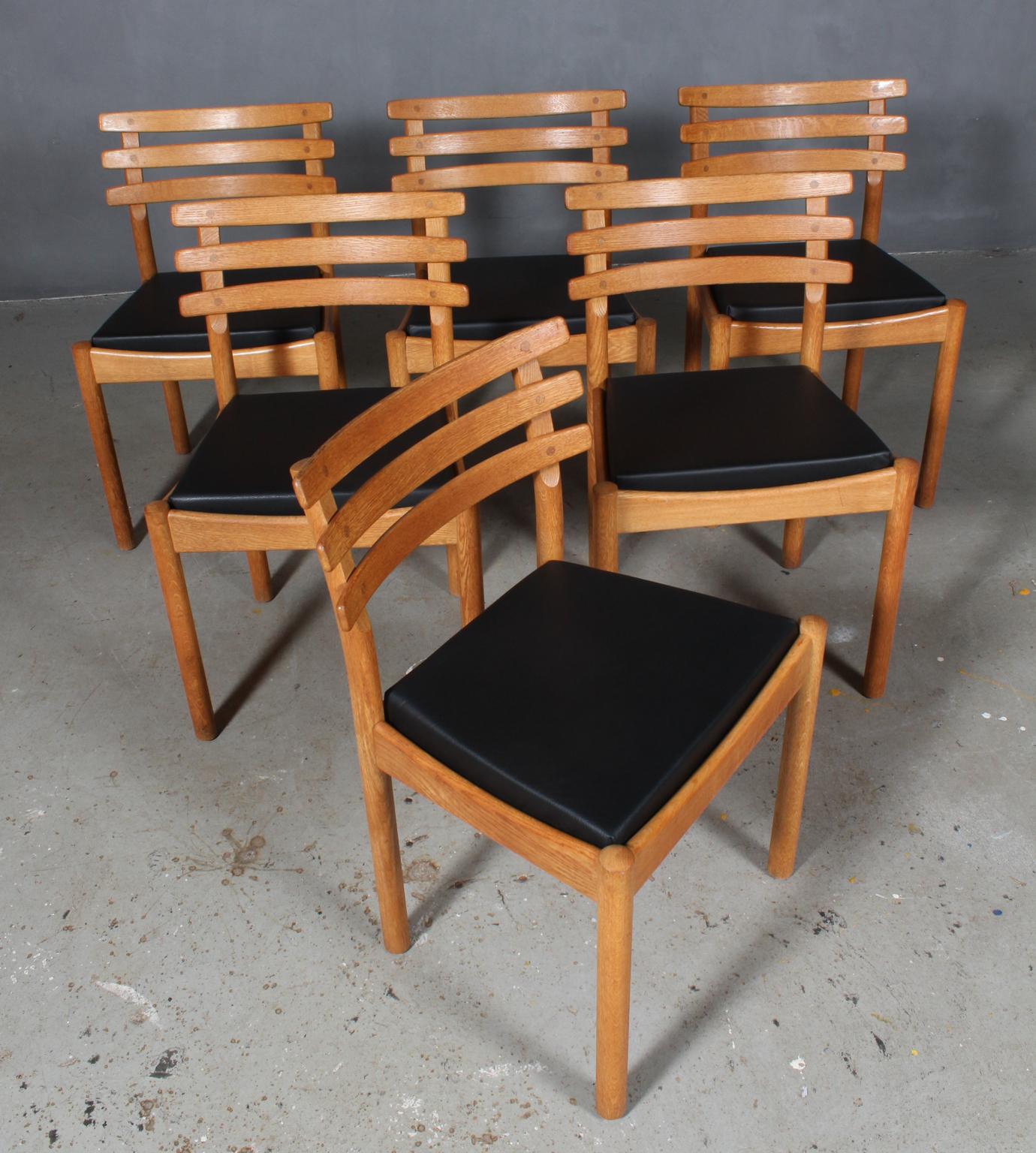 Set of six dining chairs attributed to Poul Volther with frame of oak.

New upholstered cushions with black aniline leather.

Made by FDB, probably a prototype made in the 1970s.