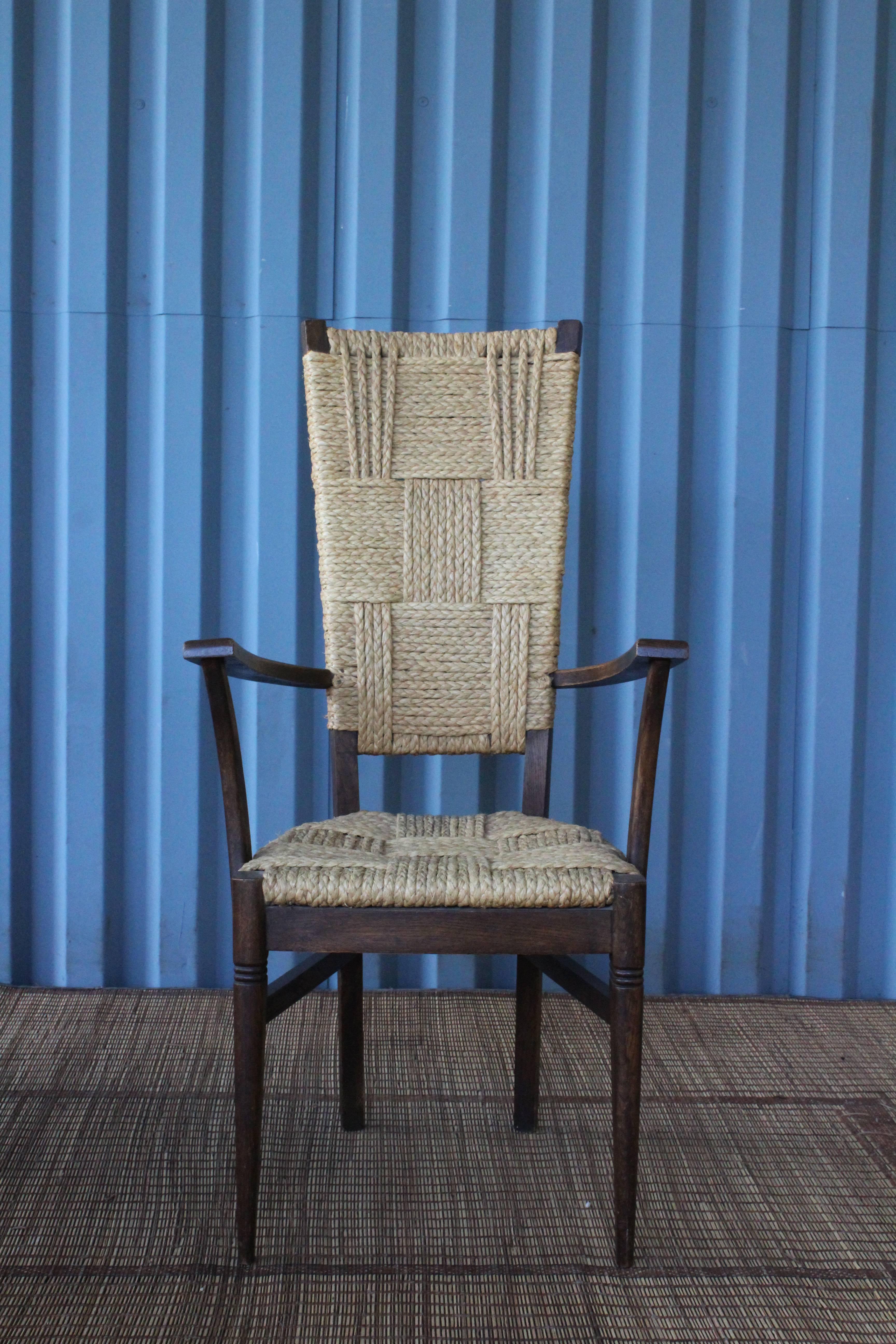 Set of six high back dining chairs designed by Frida Minet & Adrien Audoux. Includes two captains chairs and four dining chairs. The frames are in solid oak and feature woven rope seats and backrests. Wonderful condition with age appropriate wear to