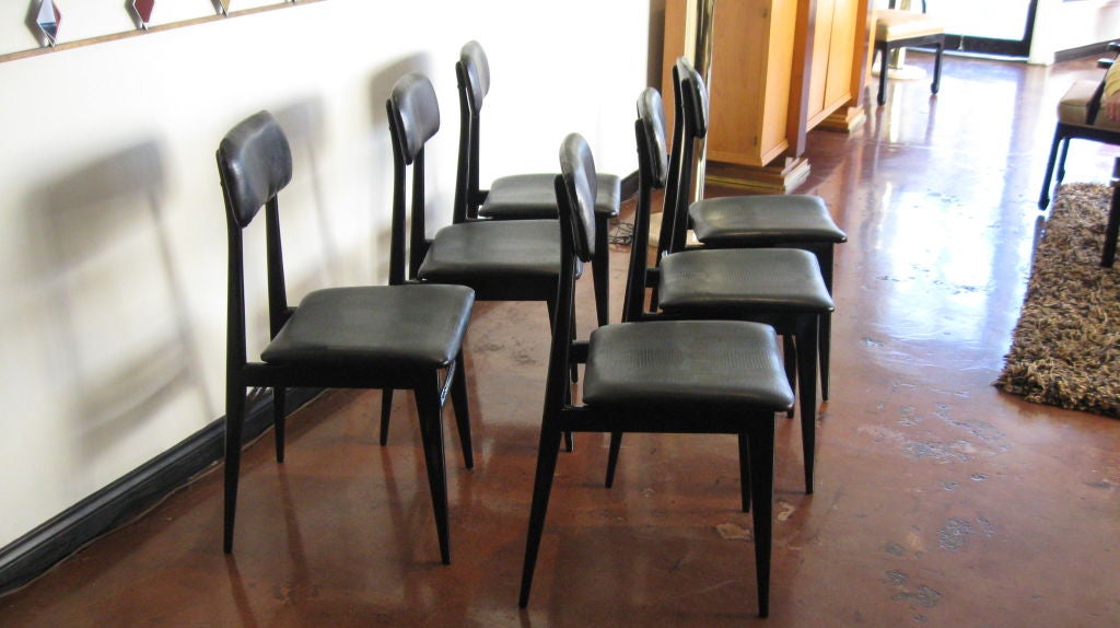 Slick set of six dining chairs by Carlo Di Carli and Gio Ponti.

Black lacquer wood. Faux python skin.