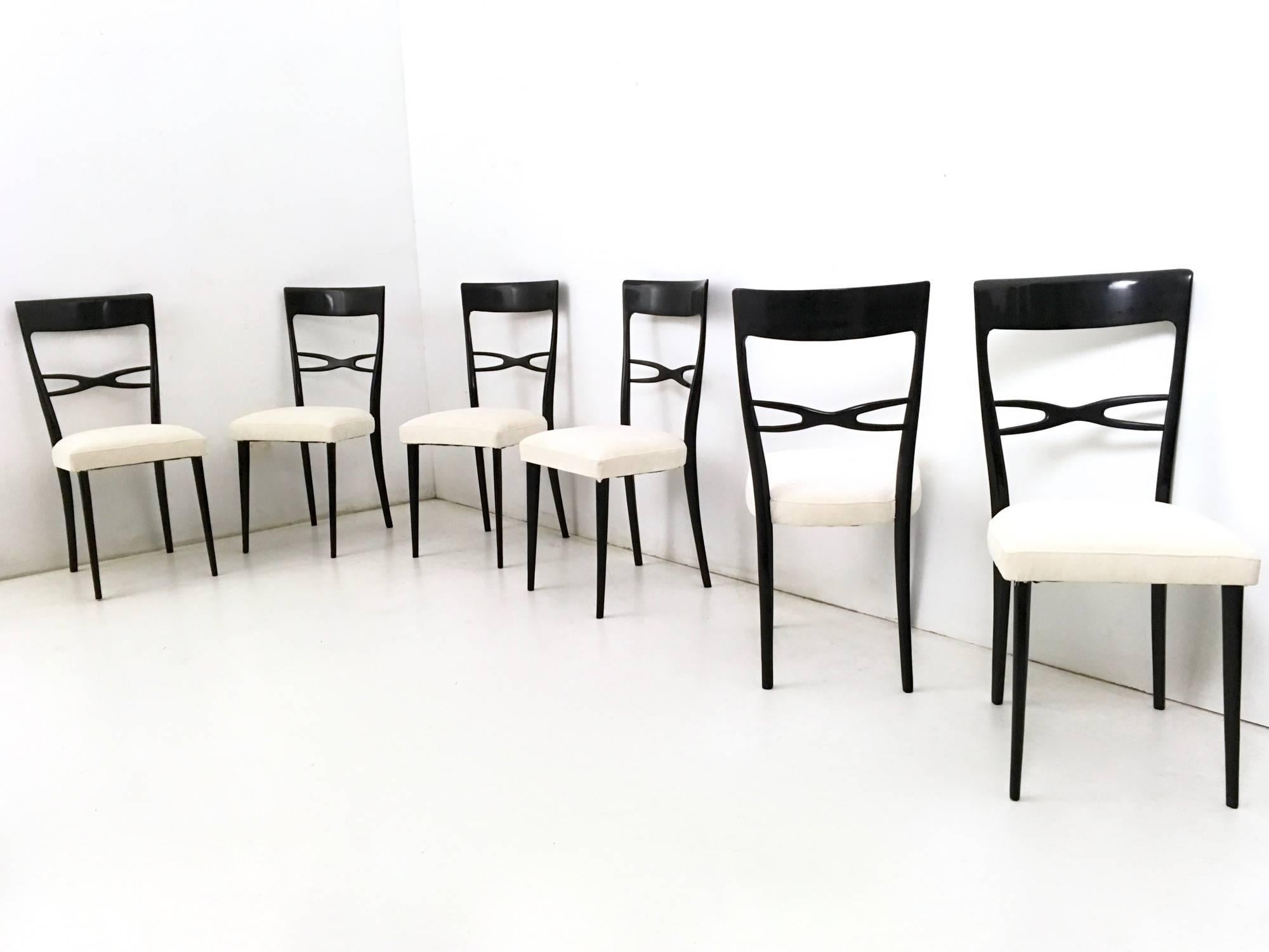 Made in ebonized wood and padding upholstered in light ivory fabric. 
They have been reupholstered and relacquered, therefore they are in perfect condition.

Measures: 
Width: 42 cm
Depth: 48 cm 
Height: 95 cm.