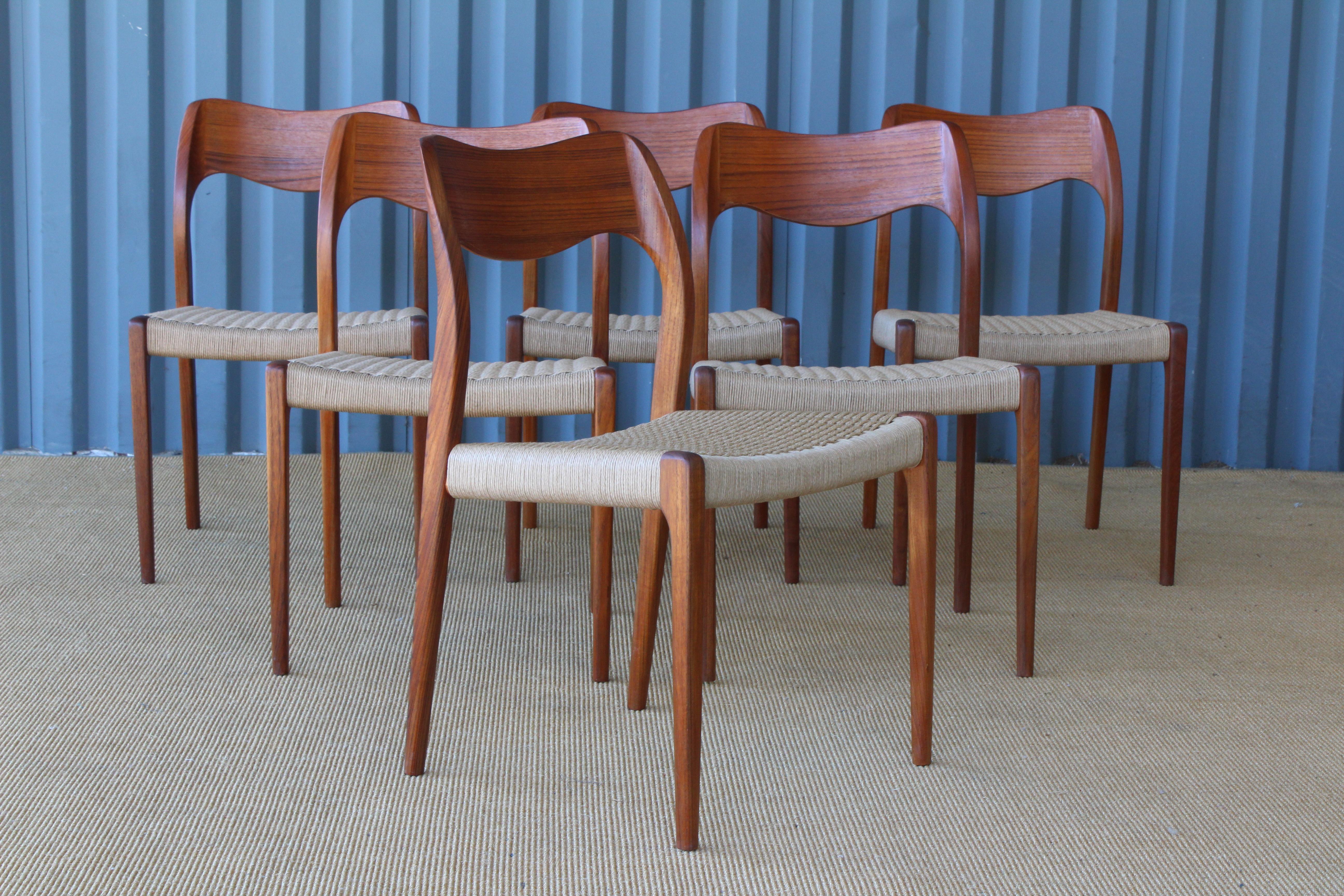 Set of six teak dining chairs by Niels Moller. The entire set of six has been completely refinished including new woven papercord seats. Price is for the set of six.