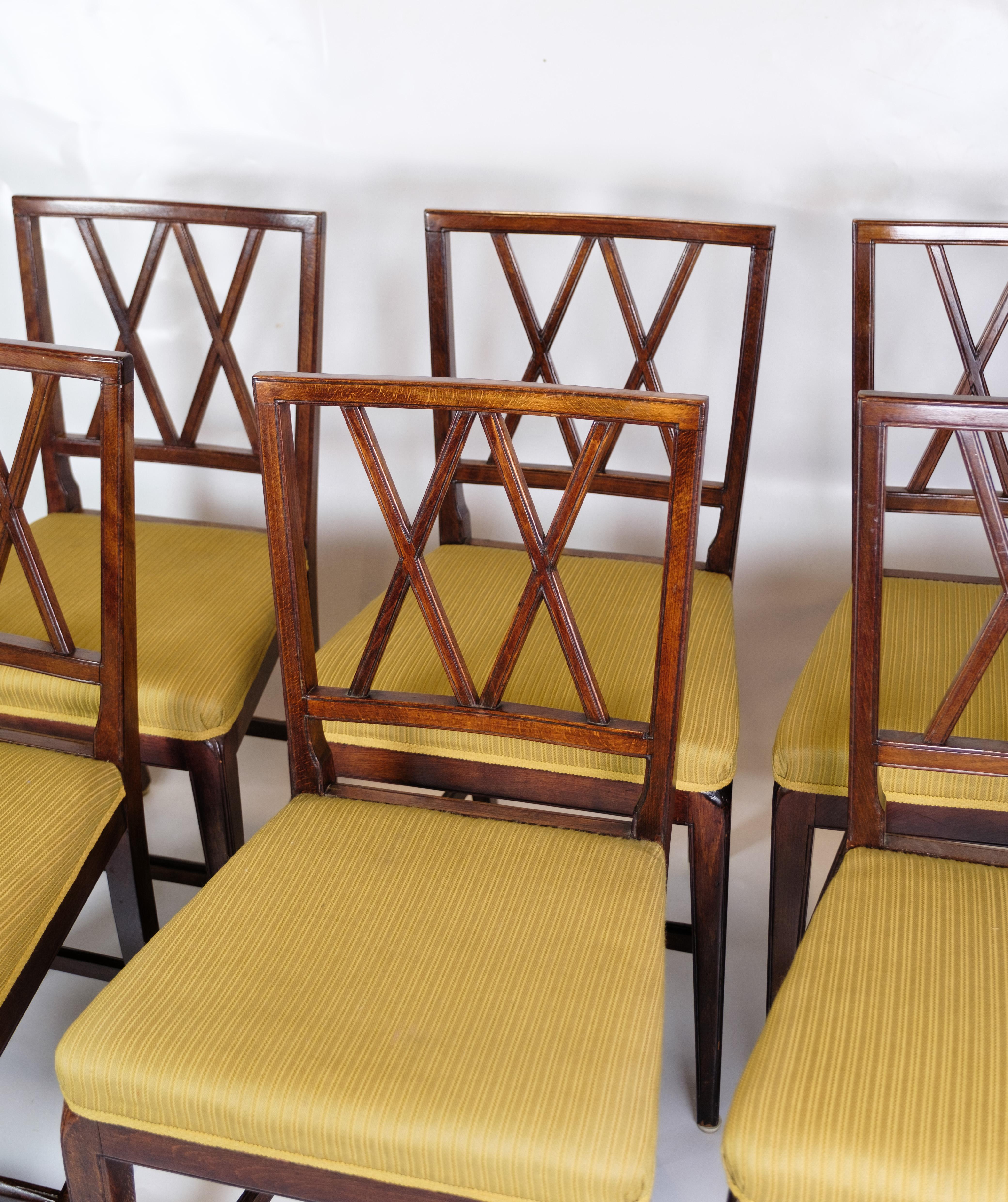 Exquisite Set of Six Dining Chairs by Ole Wanscher, Upholstered in Light Yellow Fabric, Crafted in Mahogany by A.J. Iversen in Denmark circa 1950s

Immerse yourself in the beauty of mid-20th-century Danish furniture craftsmanship with this