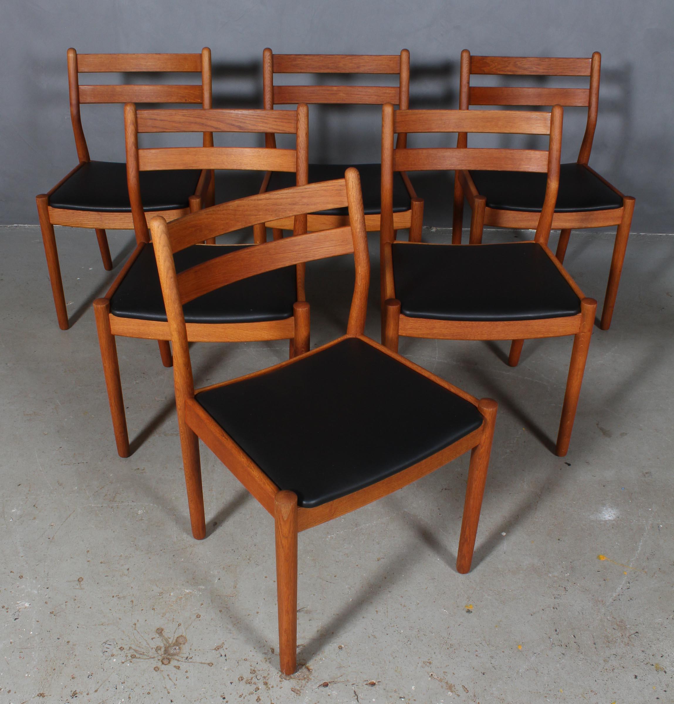 Set of six dining chairs by Poul Volther with frame of oak.

New upholstered cushions with black aniline leather.

Made by FDB, model J61.