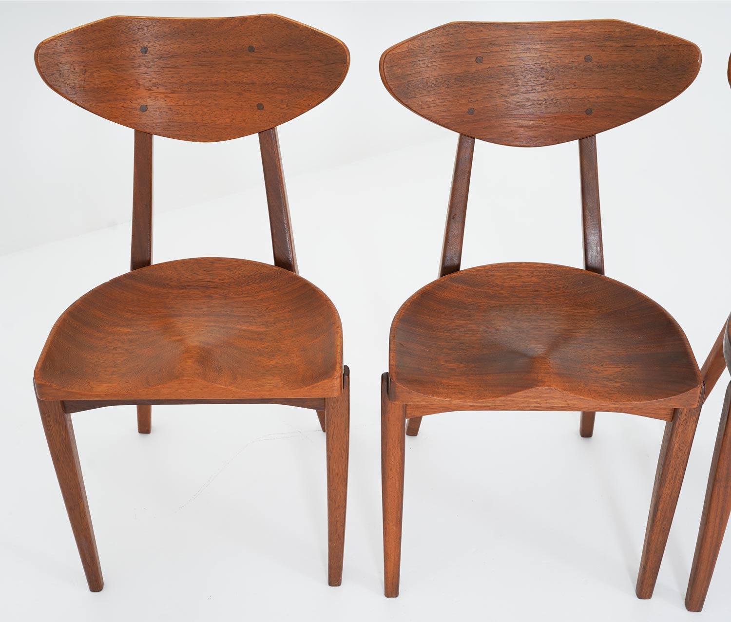 Set of 6 dining chairs by Richard Jensen and Kjaerulff Rasmussen, Denmark.
These chairs are made of solid teak. The design is inspired by traditional milk stools, with the beautifully carved seats. The chairs offer a practical handle on the