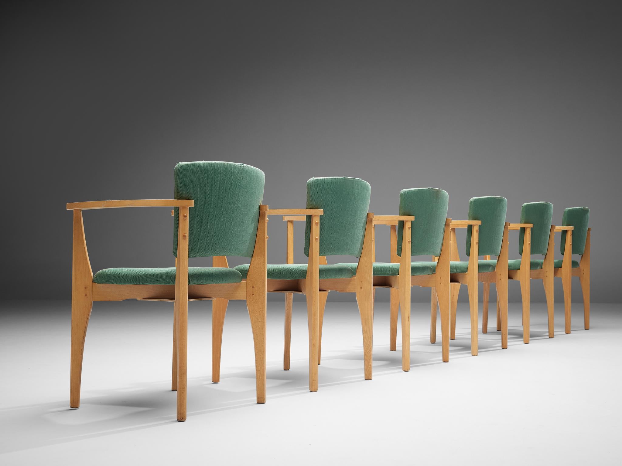 Set of SIX dining chairs, beech, fabric, Europe, 1960s

Set of SIX dining chairs, made in Europe in the 1960s. These dining chairs feature frames in a light beech wood. They show rounded armrests that are connected to the legs in front and at the
