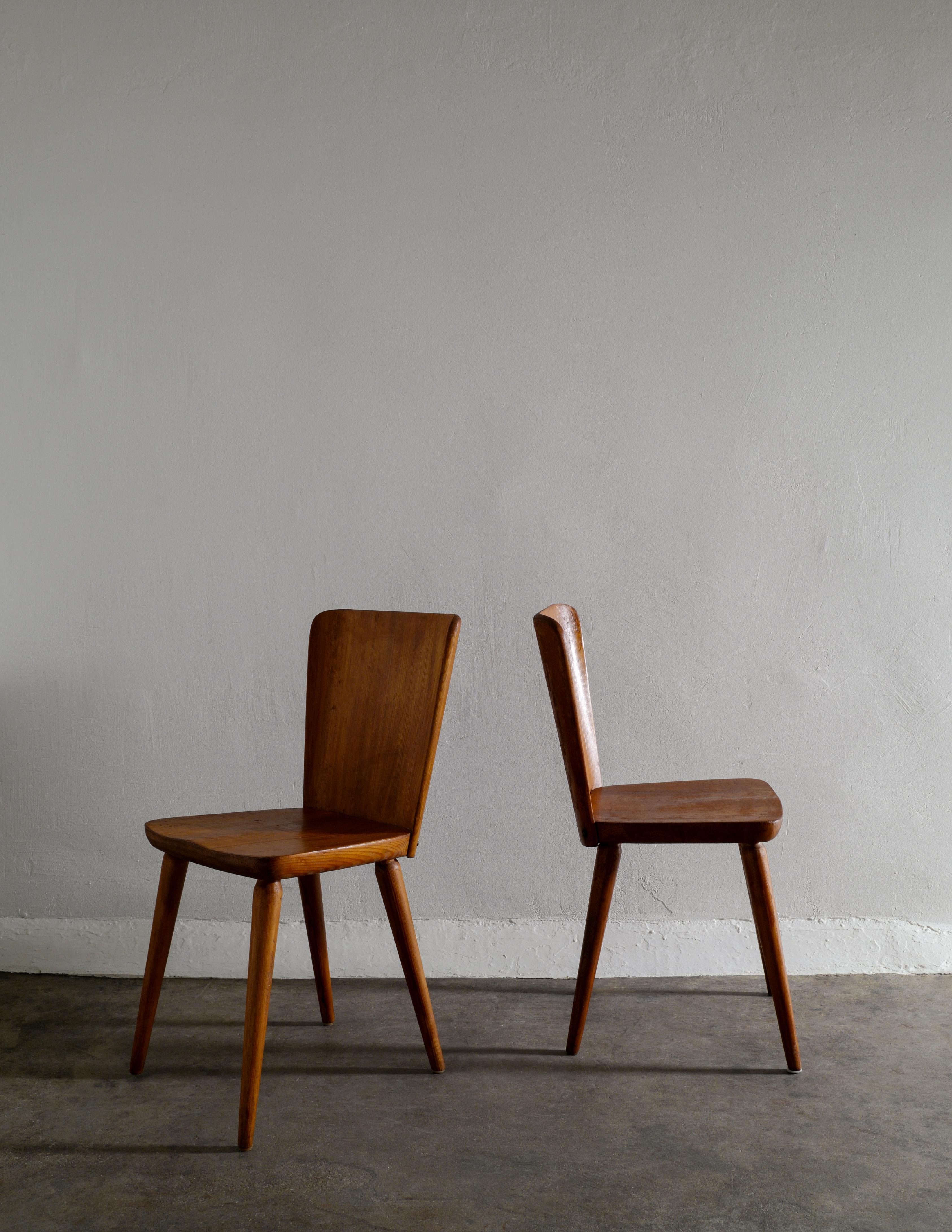 Rare set of six dining chairs in stained pine designed by Göran Malmvall for Svensk Fur in Swede during the 1940s. In good vintage condition with signs from age and use, all chairs have most likely been re-stained with a darker finish over the years