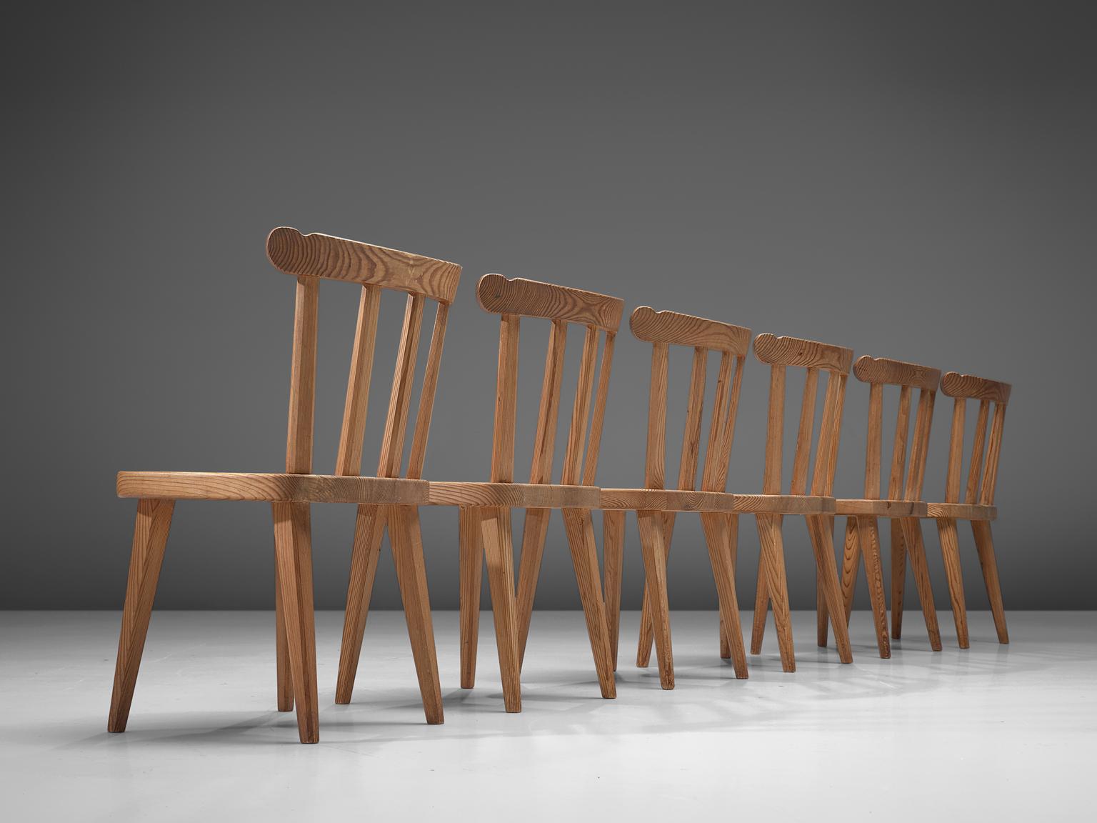 Nordiska Kompaniet, set of 6 dining chairs 'Ekerö, pine, Sweden 1930s. 

Elegant set of six dining chairs. Executed in northern European pinewood. The design is simplistic; four tapered legs, solid seating and spindel or slat back. These chairs have