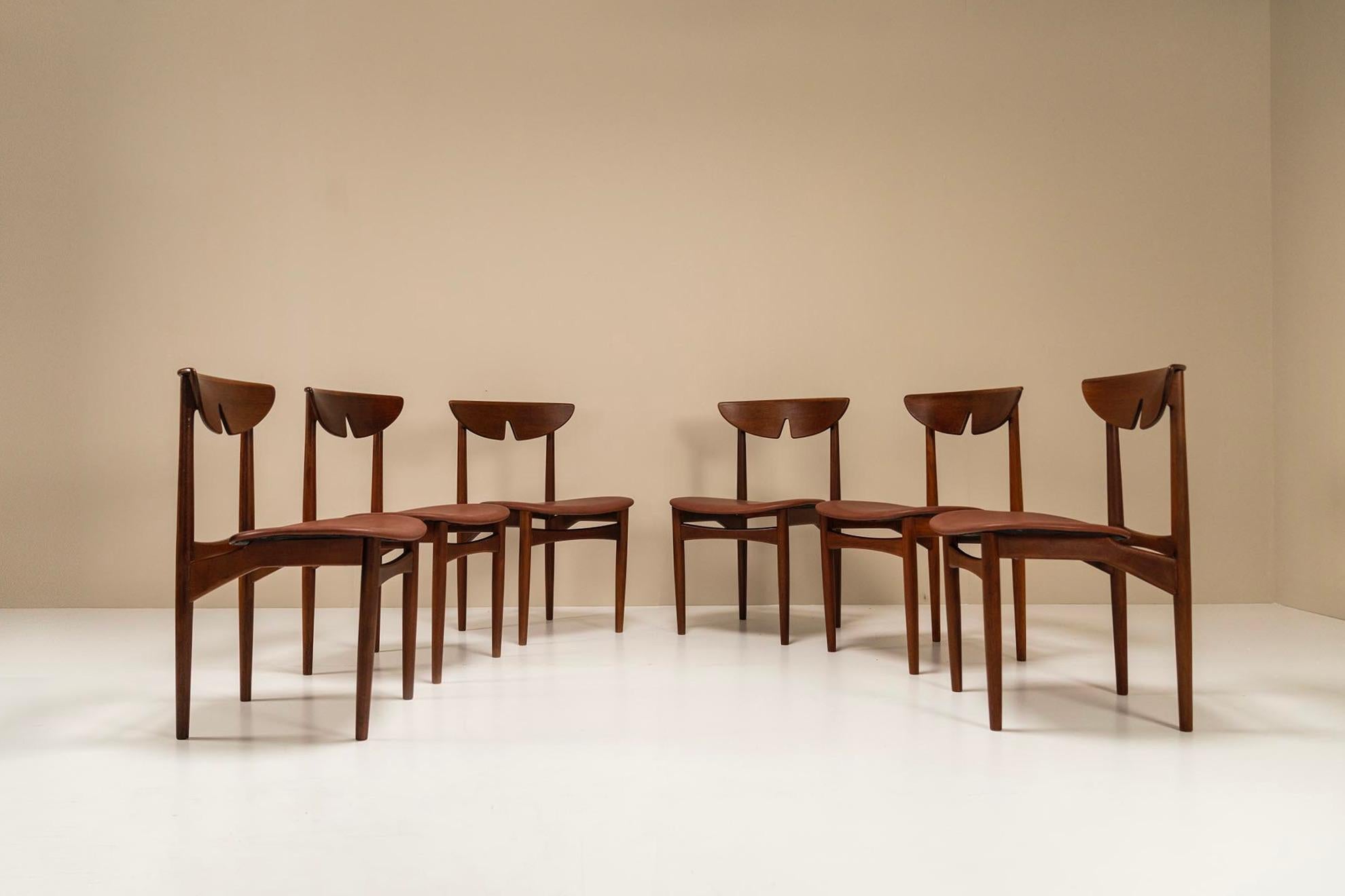 A set of six very charming Danish dining room chairs from the 1960s that strongly remind us of the designs of Peter Hvidt and Orla Mølgaard. The frame is made entirely of teak and is particularly striking because of the top rail, or the backrest. It
