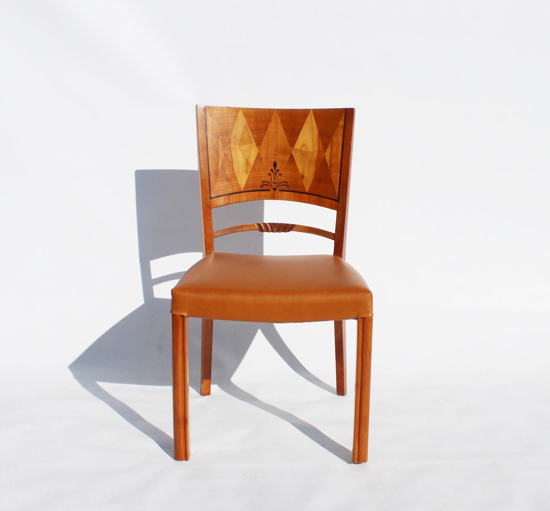 Set of six, cabinet masterwork dining chairs of different types of wood and newly upholstered with cognac colored elegance leather. The chairs are in great vintage condition and from the 1950s.

This product will be inspected thoroughly at our