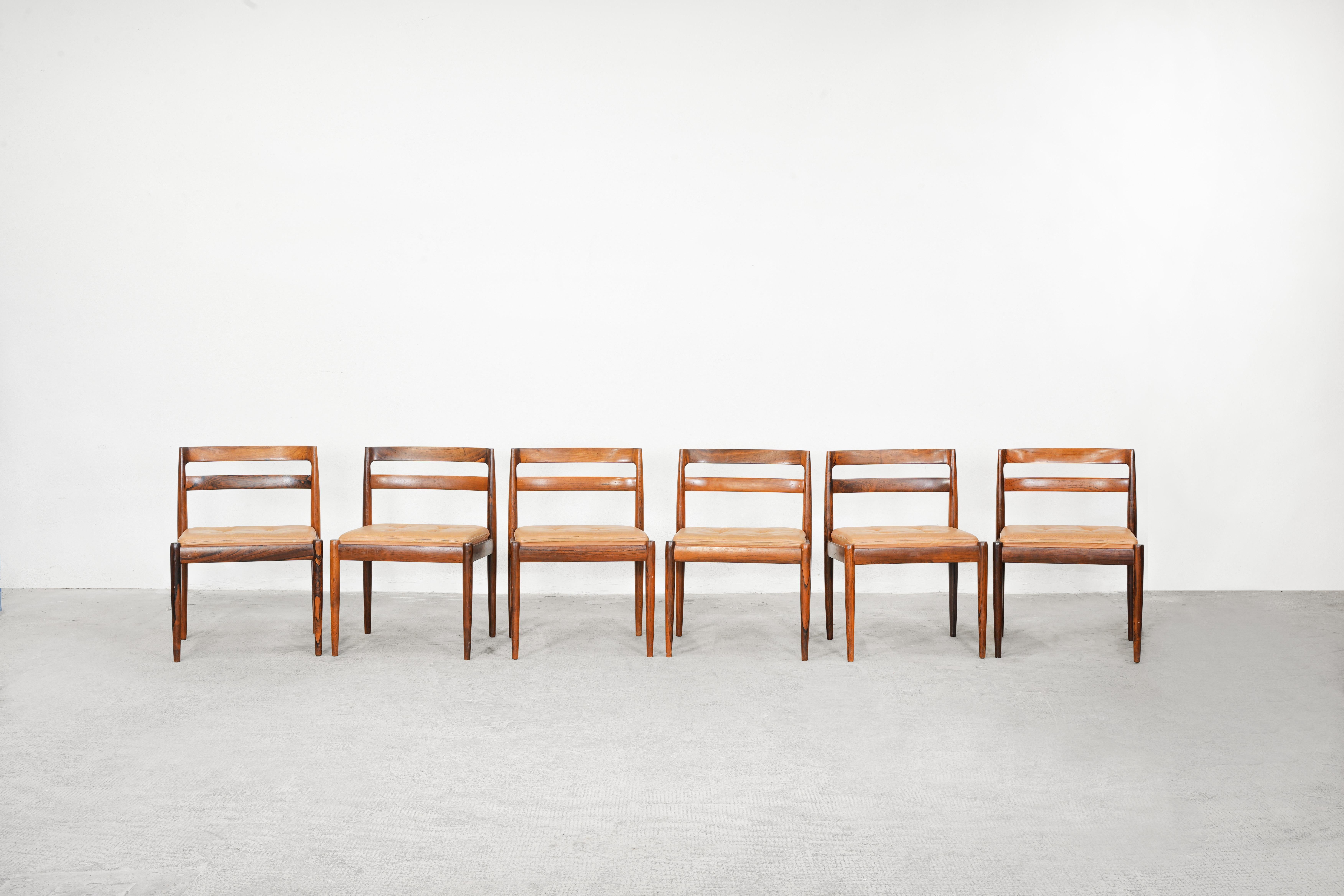 Beautiful set of six dining chairs mod. 301 designed by Kai Kristiansen and produced by Magnus Olesen in the 1960ies in Denmark.
All chairs are in great original and used condition and come in dark wood and leather cushions.
  