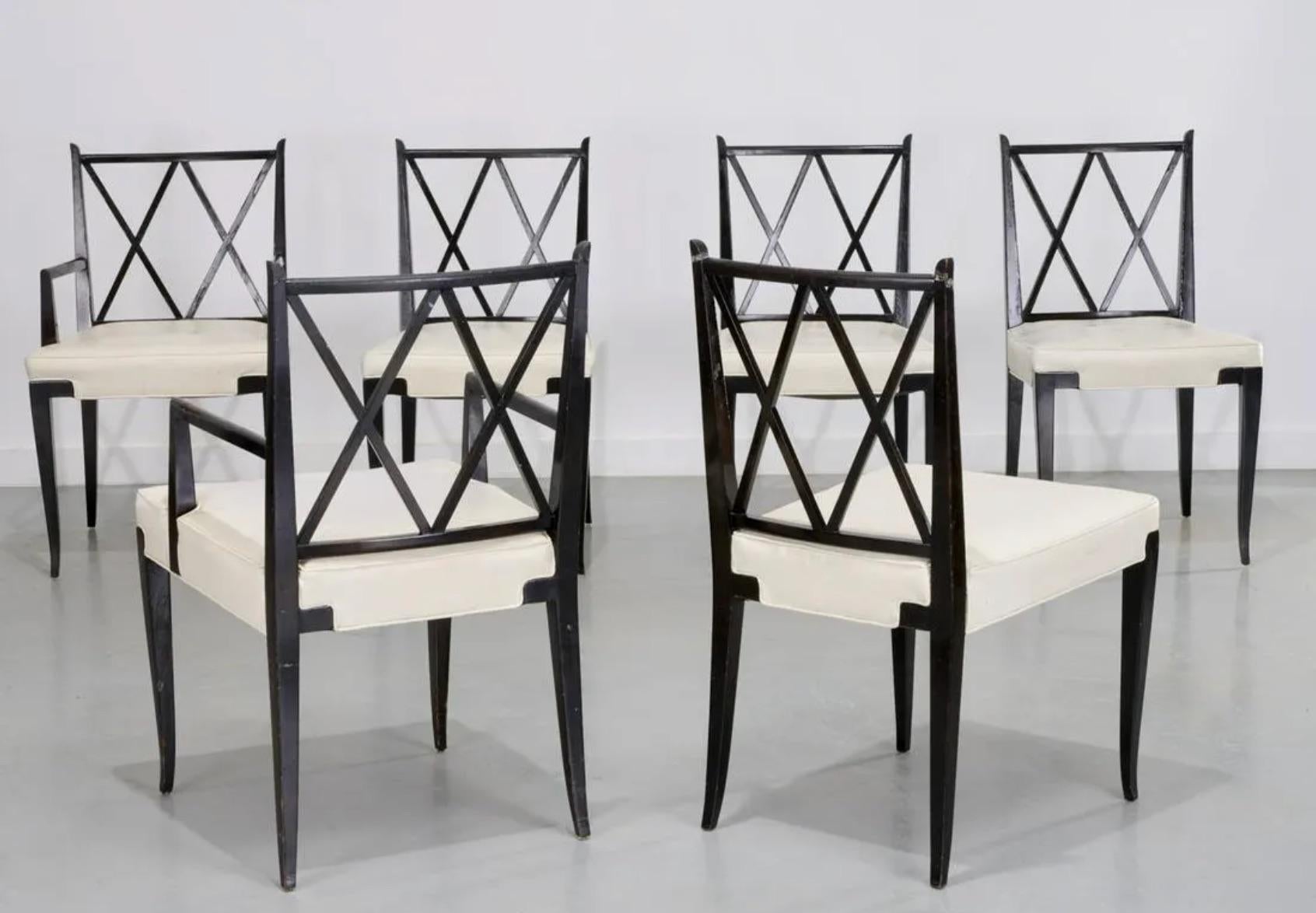 A classic set of six ebonized mahogany dining chairs designed by Tommi Parzinger for Parzinger originals, circa 1950. Two arm chairs and four side chairs included in this set Upholstered in White Performance Linen. Beautiful and graceful design with