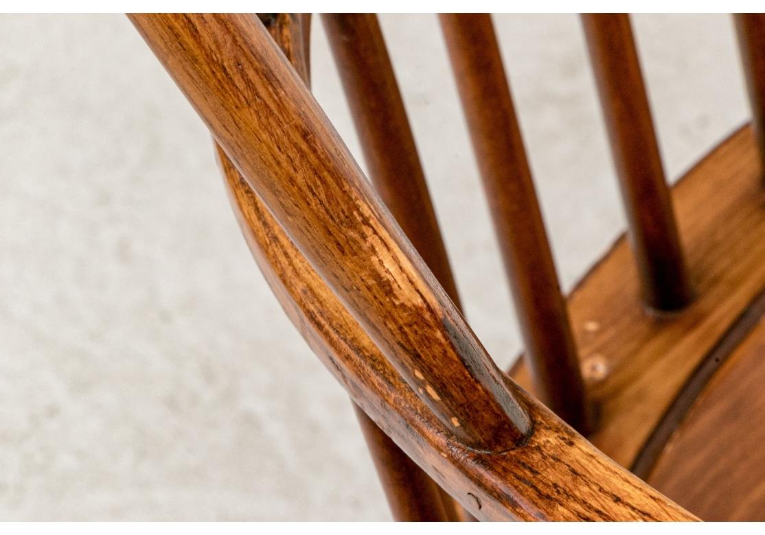 Set of six Honey tone Windsor dining chairs comprised  of two Sack Back arm chairs and  four Bow Back side chairs by master furniture maker D.R. Dimes. 
Each is branded D.R. Dimes underneath the seat. All are raised on turned splayed legs with H