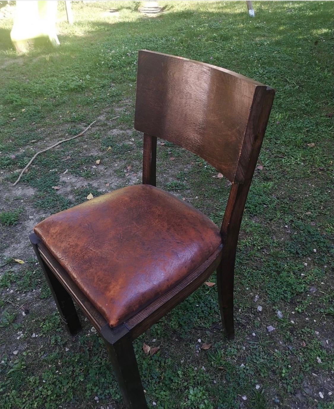 A set of six Charles Dudouyt chairs in leather and oak.